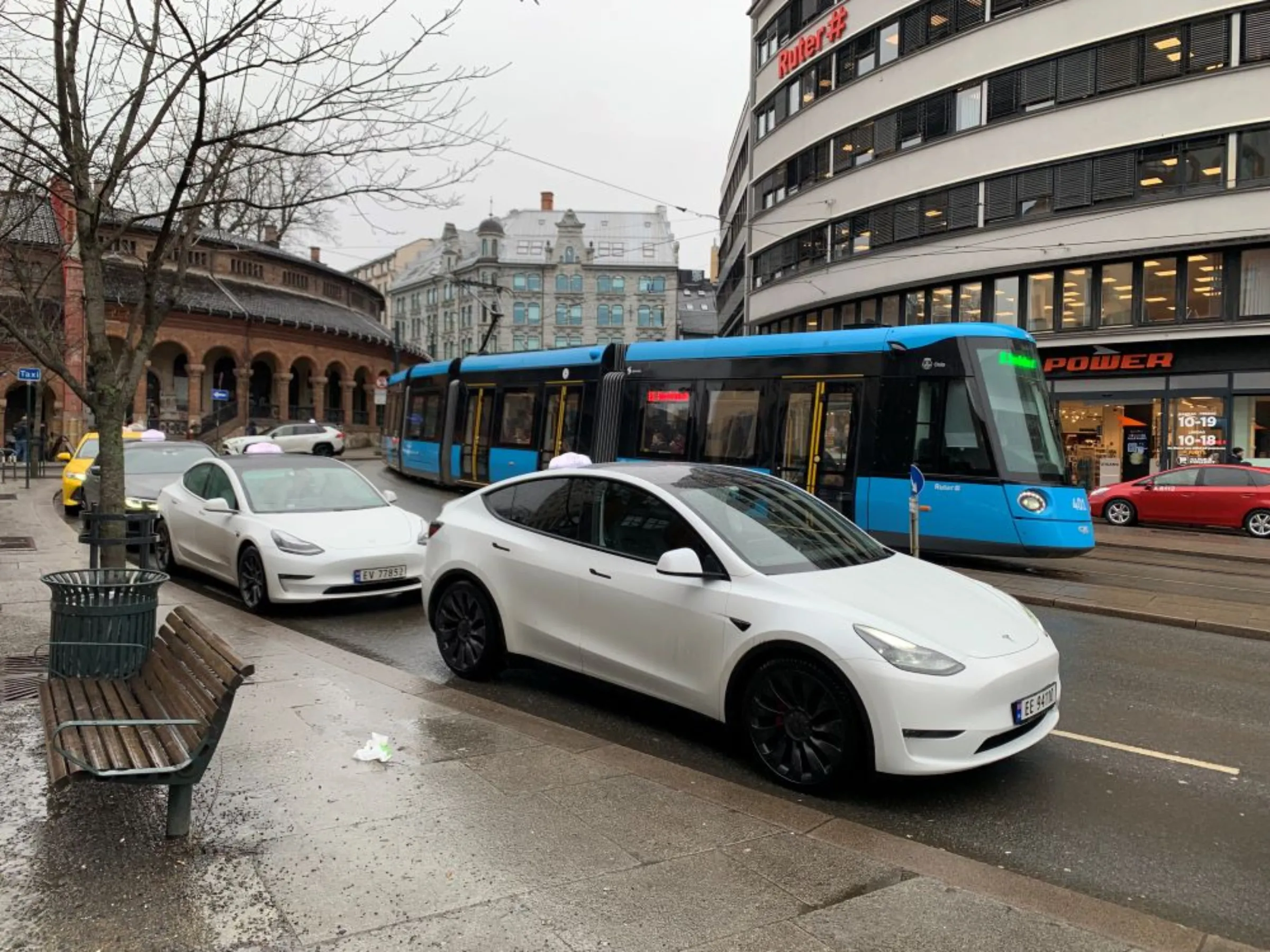 An electric tram passes electric taxis waiting for clients in central Oslo, March 24, 2023. Oslo is set this year to become the world’s first capital city with only electric public transport