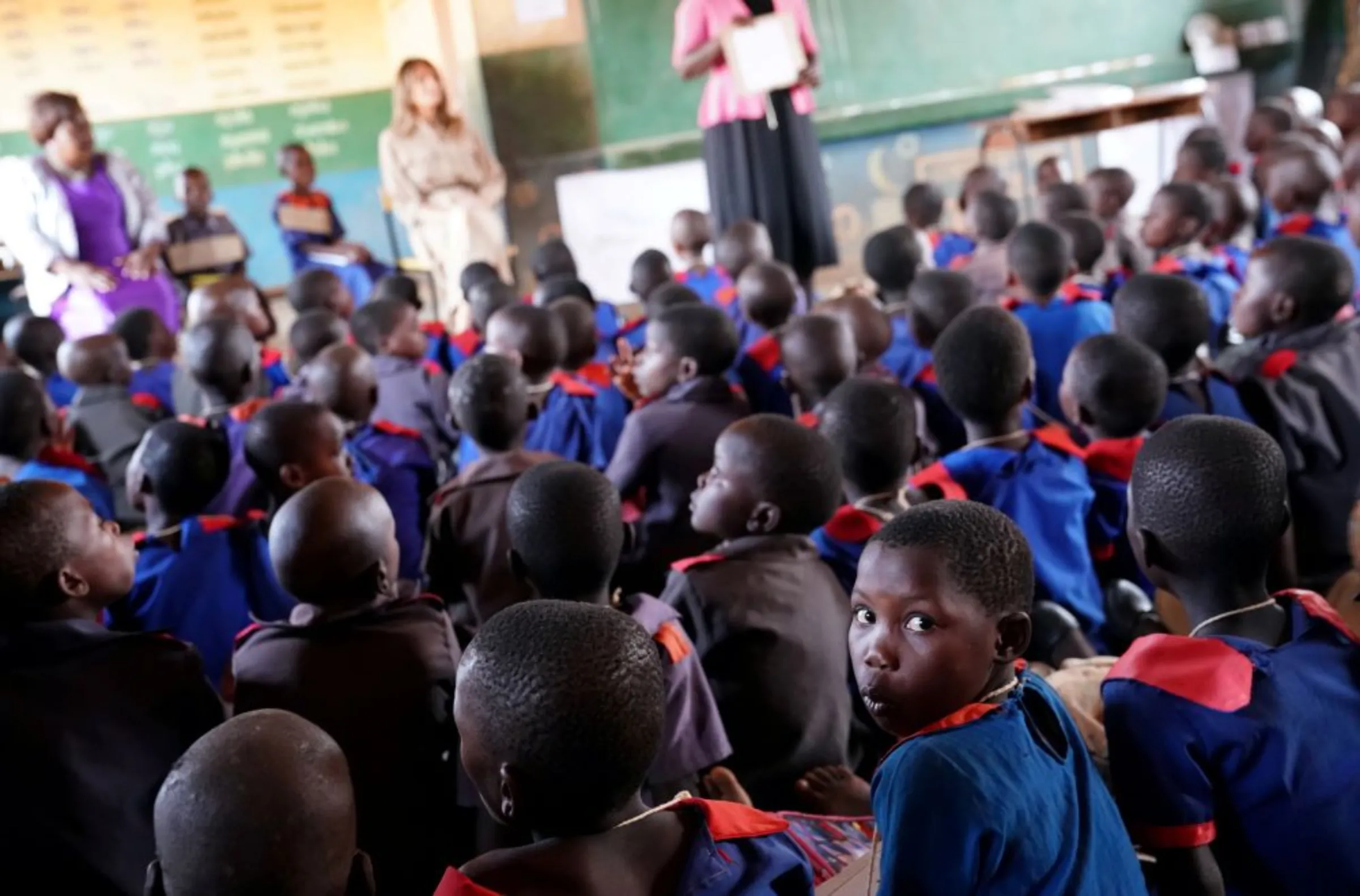 Children look on as U.S. first lady Melania Trump visits a school in Lilongwe, Malawi, October 4, 2018. REUTERS/Carlo Allegri