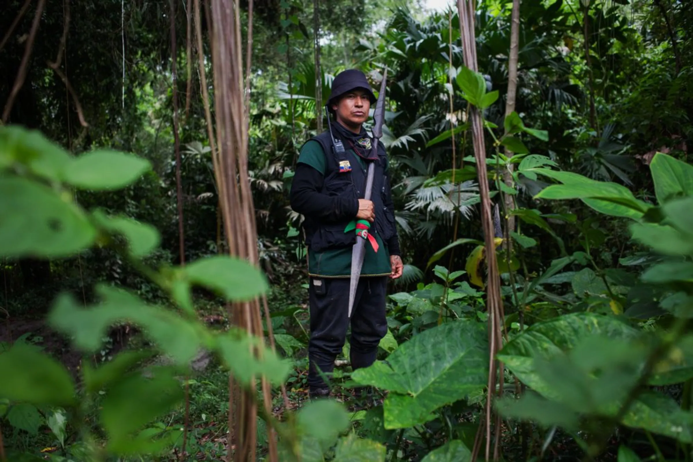 Marcelo Lucitante, a member of the Cofan indigenous guard, in the Amazon rainforest in northern Ecuador, holds a spear while on patrol near his village of Sinangoe, on April 21, 2022. Indigenous guards patrol their ancestral lands to keep illegal gold miners, poachers and hunters at bay