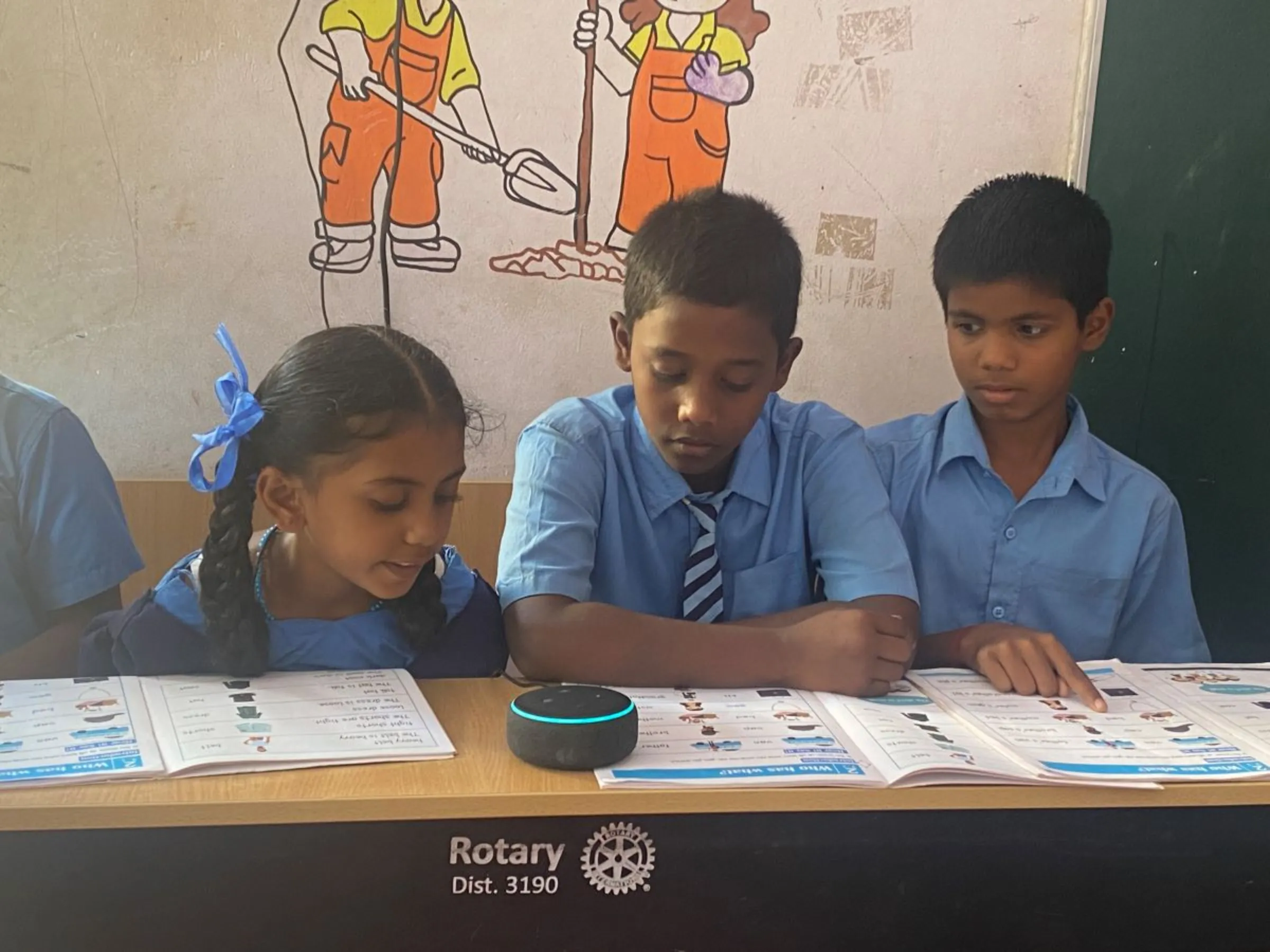 Students at a government-funded school practise English with an AI-enabled device in the southern city of Bengaluru, India. October 5, 2023. Thomson Reuters Foundation/Rina Chandran