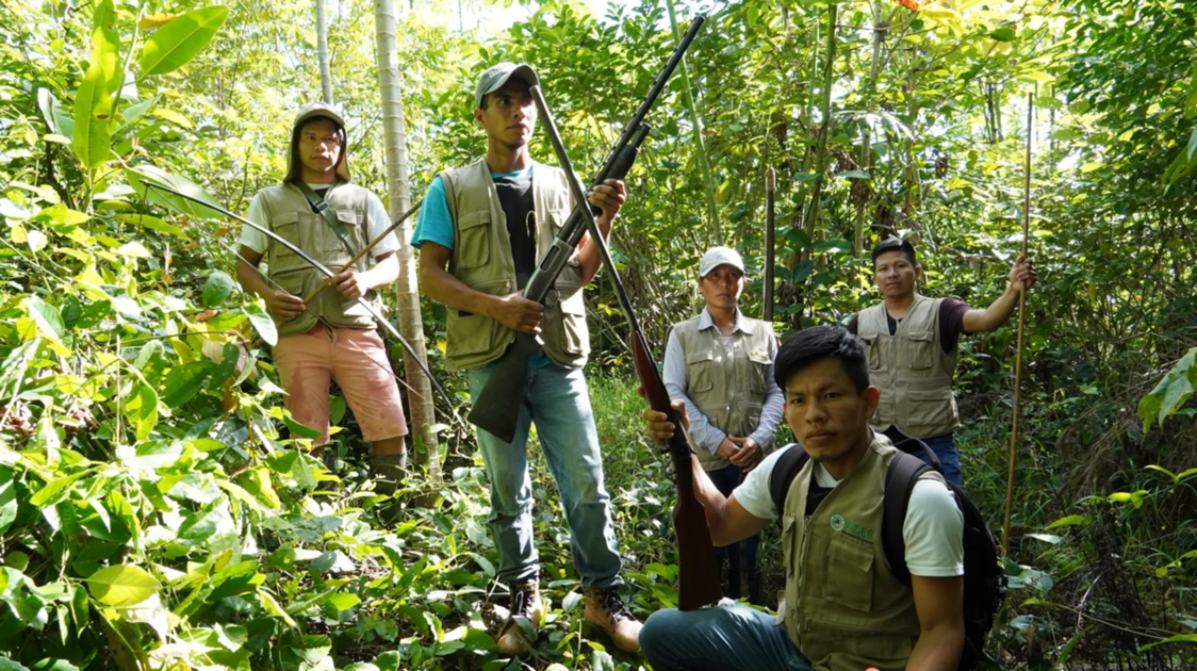 A group of indigenous land defenders pose for a photo in a forest near Flor de Ucayali, Peru, 6 June, 2022. Thomson Reuters Foundation/Dan Collyns