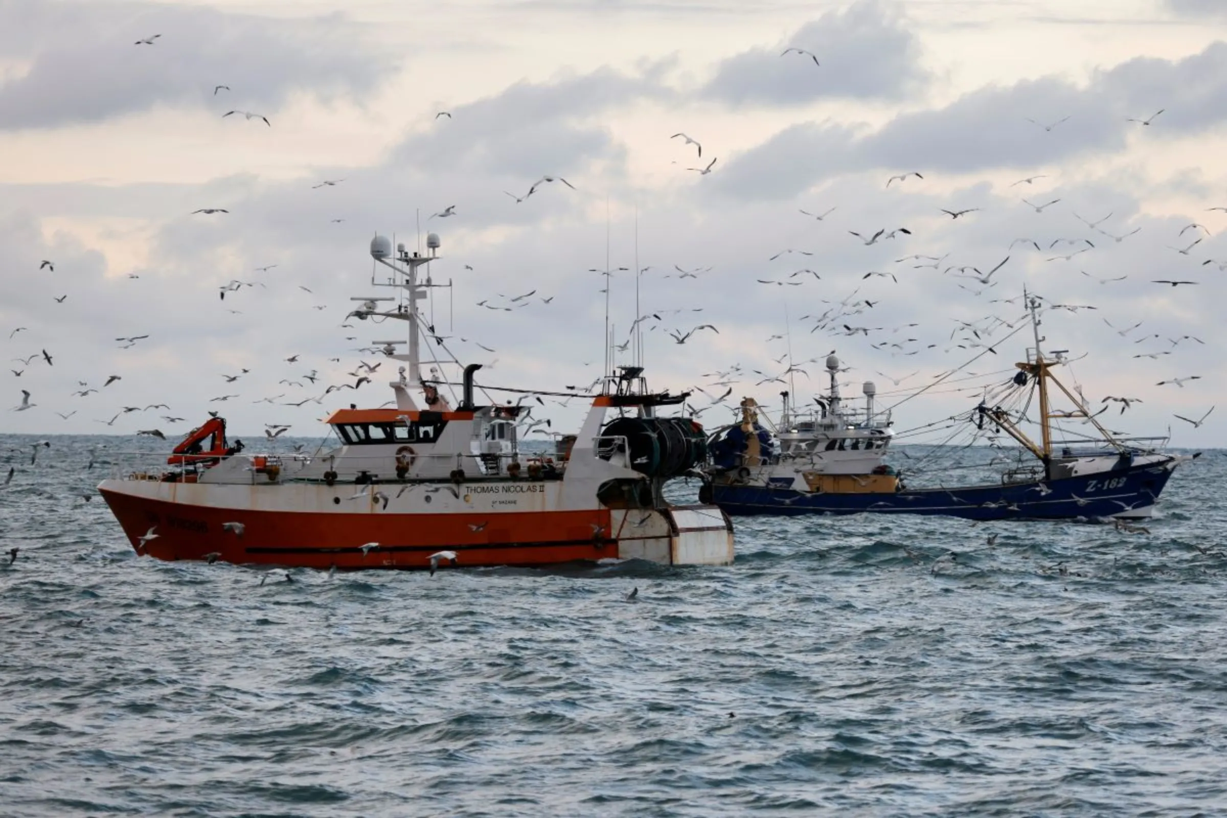 The French trawler 'Thomas Nicolas II' sails past a Dutch trawler in the North Sea, off the coast of northern France, December 7, 2020.  REUTERS/Pascal Rossignol