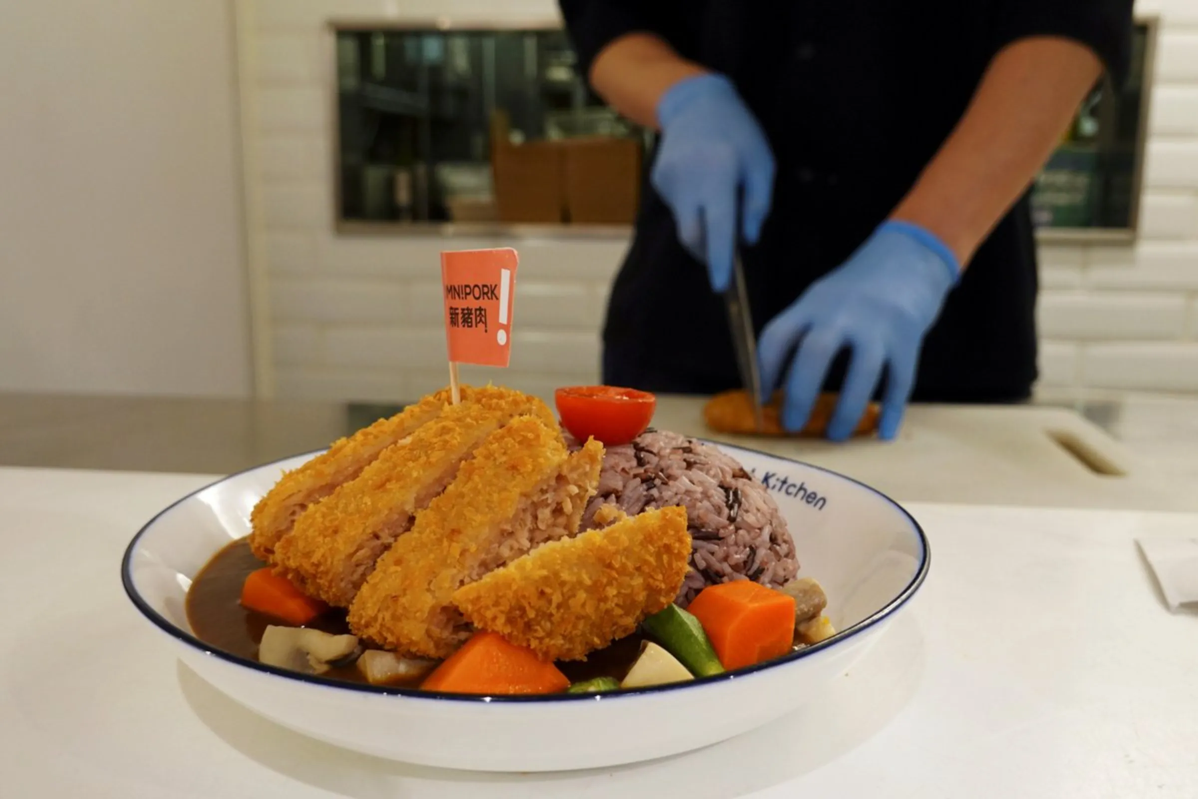 A pork cutlet dish made with plant-based meat Omnipork is displayed for the camera at vegan restaurant Kind Kitchen in Hong Kong, China April 17, 2020.