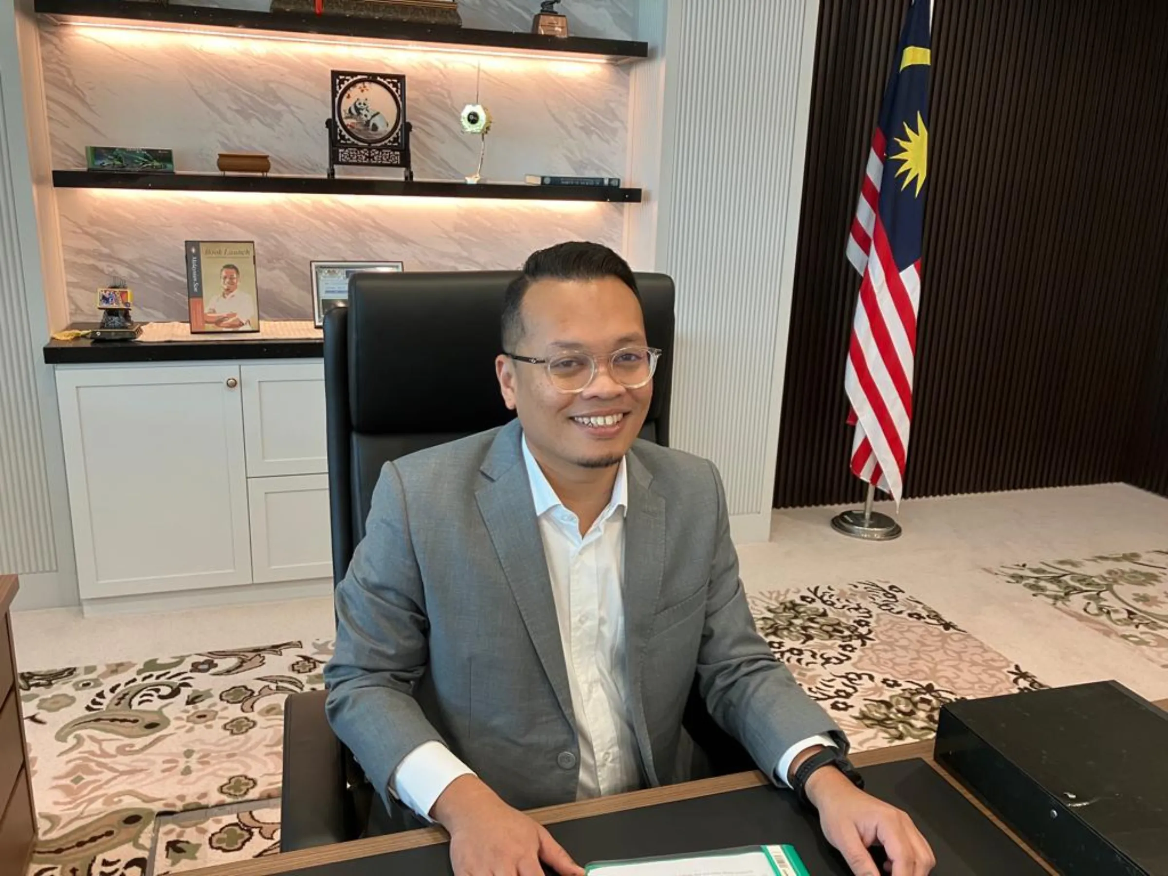 Minister of natural resources, environment and climate change, Nik Nazmi Nik Ahmad, poses in his office in Putrajaya, Malaysia on April 26, 2023. Thomson Reuters Foundation/Michael Taylor