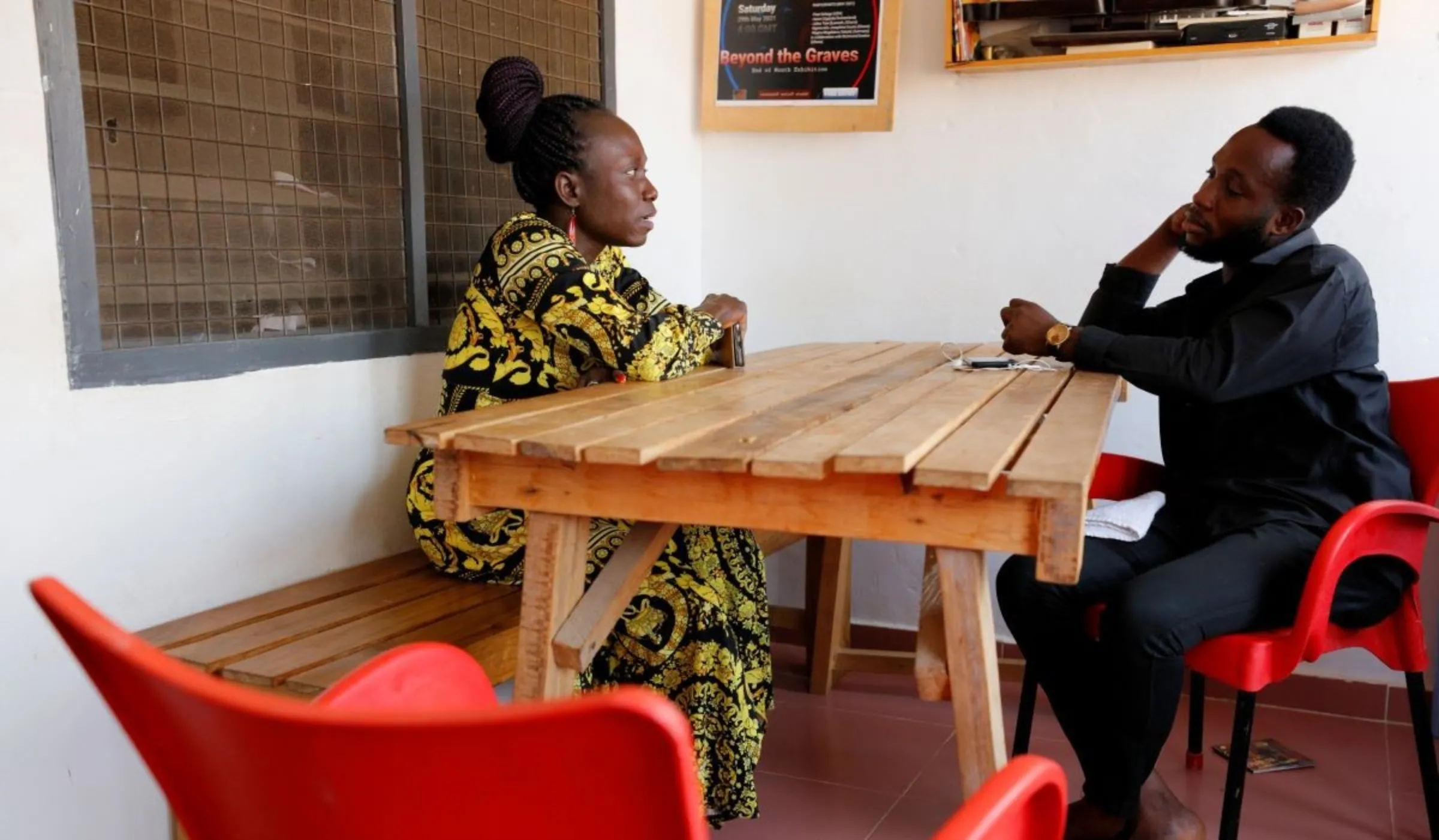 Va-Bene Elikem Fiatsi, 40, a trans woman who is an artist and LGBT+ activist, meets with Richmond Anokye, 22, a member of the LGBTQ+ community at her home and studio in Oduom, Ashanti Region-Ghana, December 22, 2021. REUTERS/Francis Kokoroko