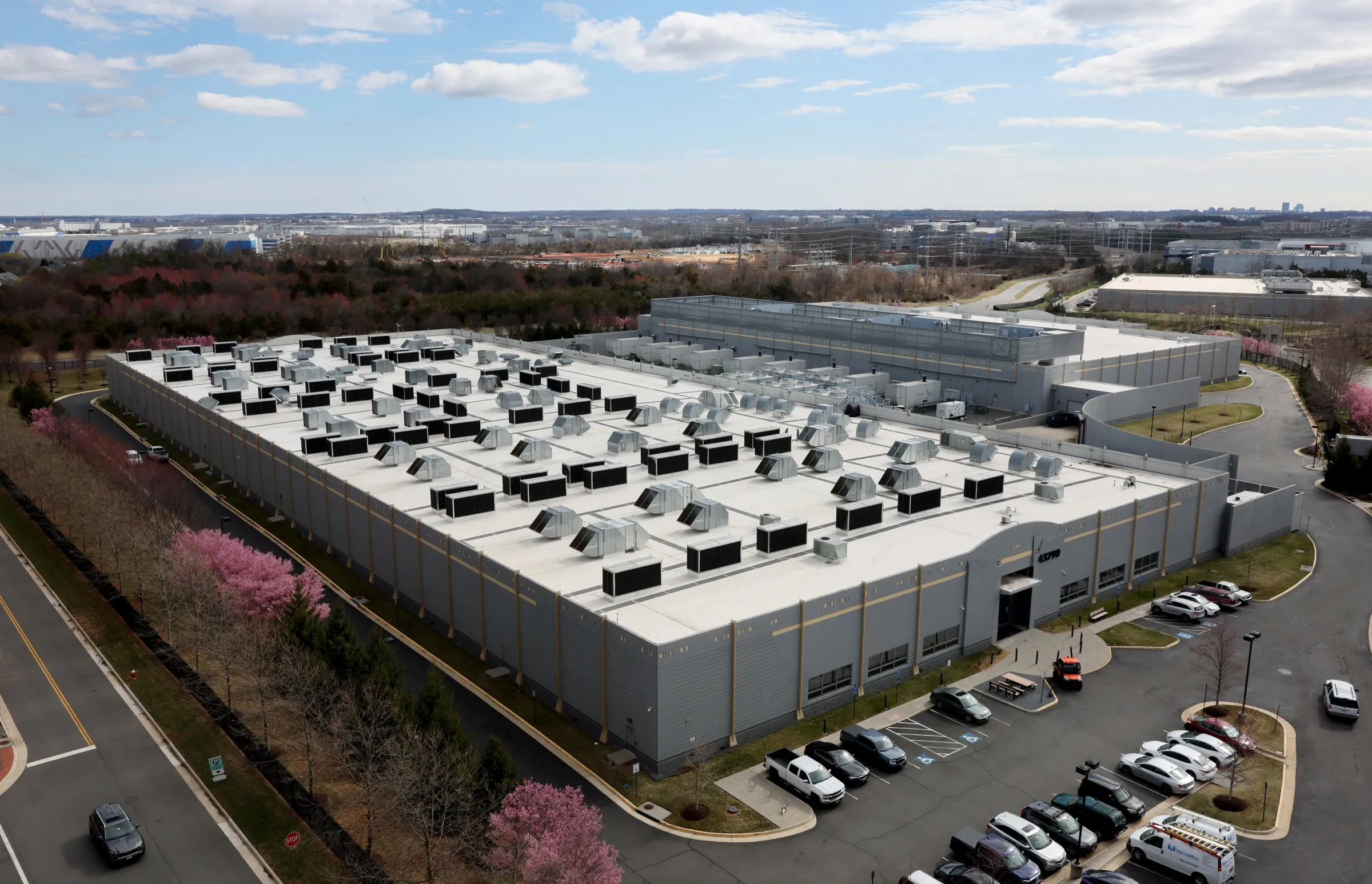 A car drives past a building of the Digital Reality Data Center in Ashburn, Virginia, U.S., March 17, 2025. REUTERS/Leah Millis