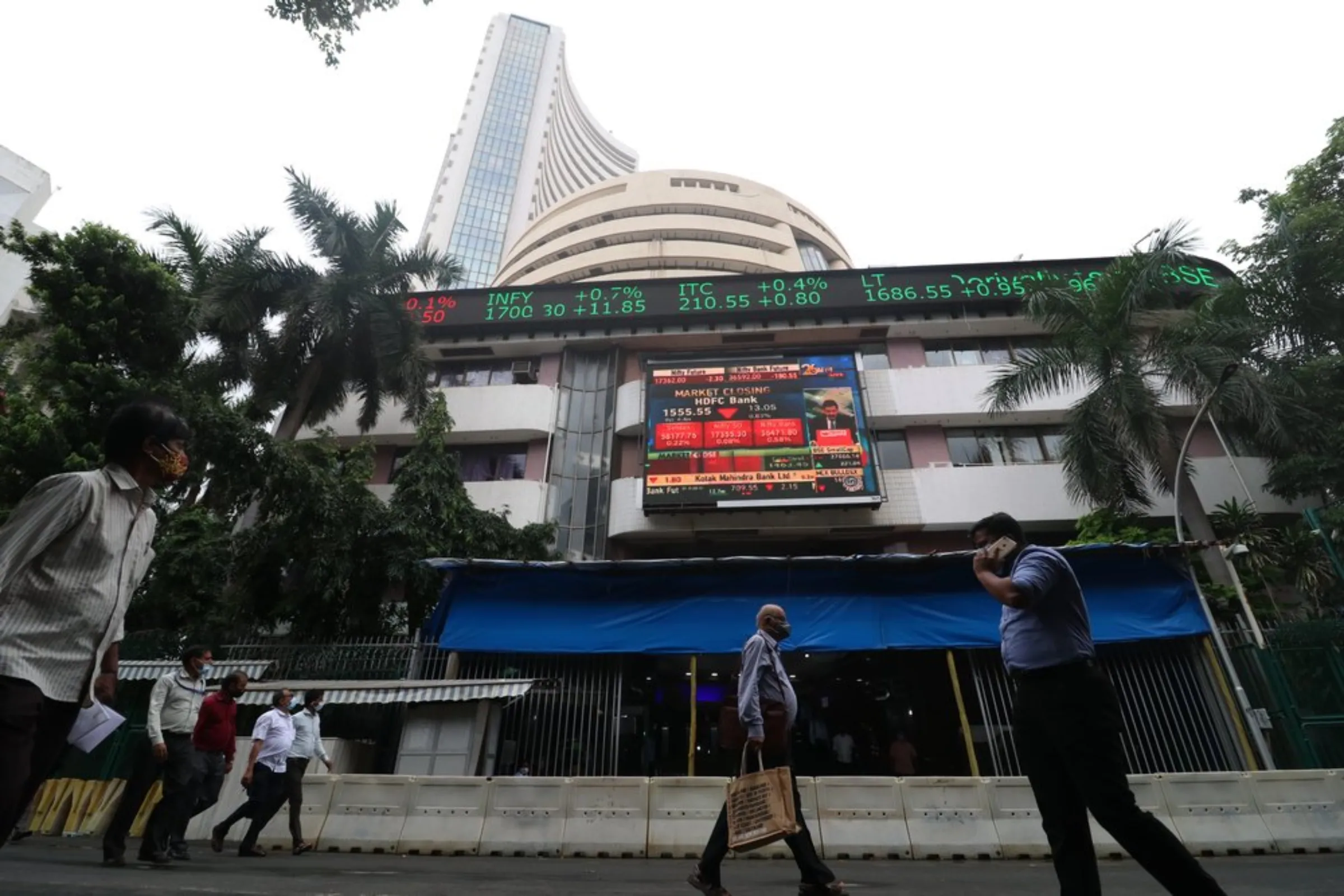 People walk past the Bombay Stock Exchange building in Mumbai, India, September 13, 2021