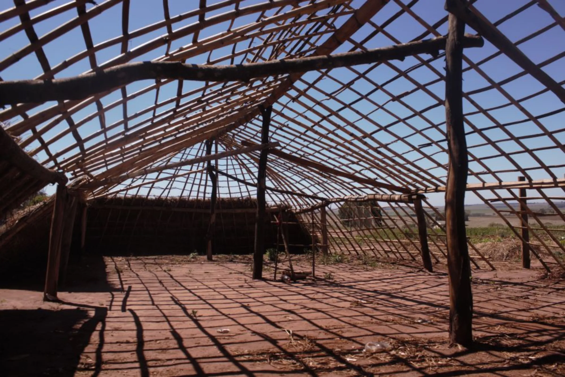 Inside of a prayer house (“oga pysy” in Guarani) under construction near barracks in the Guapoy occupation, by the Amambai Indigenous Reserve, in Amambai, Brazil, September, 17, 2022. Thomson Reuters Foundation/André Cabette Fábio
