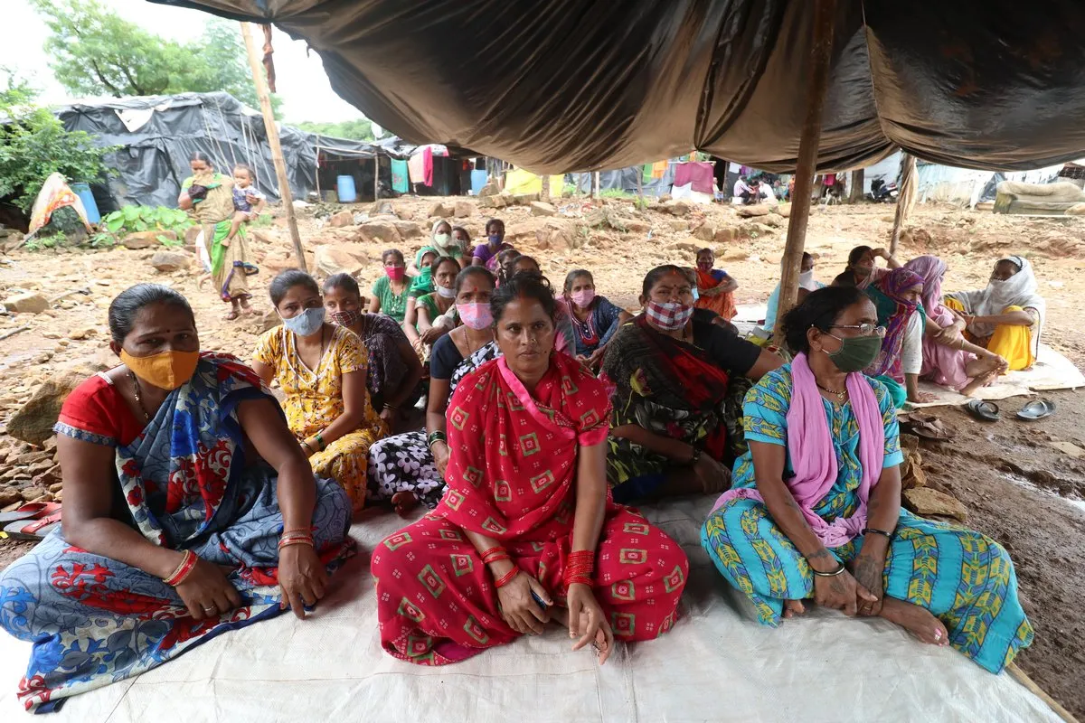 Munni Goud, at centre in red, and other residents of the Ambedkar Nagar slum take part in a protest demanding new housing and better protection from floods after their houses were destroyed – and Goud’s 22-year-old son killed - when a water storage retaining wall collapsed in 2019 during heavy rains in Mumbai, India, September 6, 2021