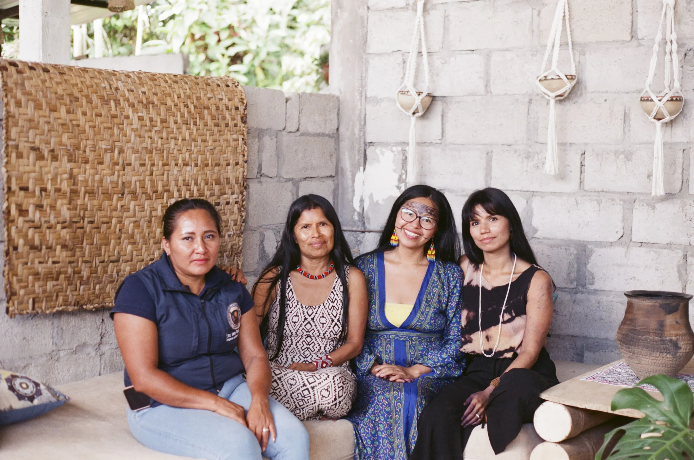 Four women sit next to each other in a women's centre