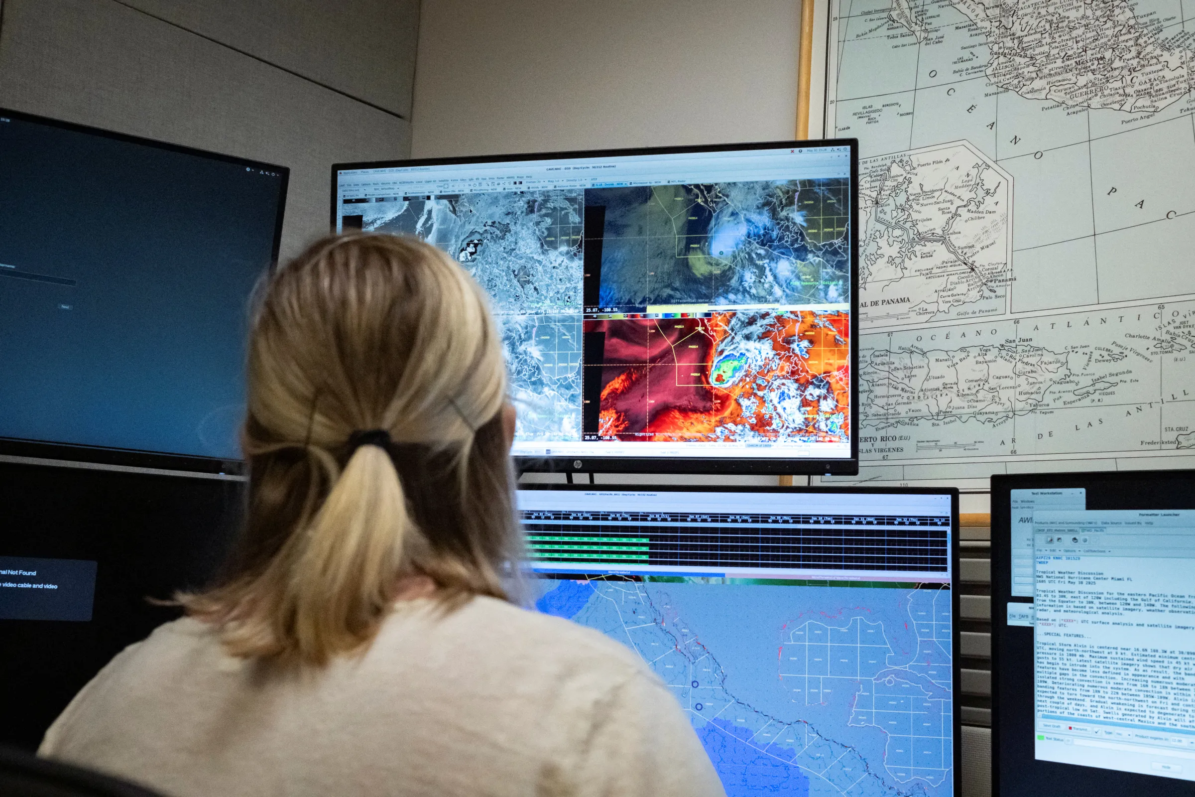 A marine forecaster looks at monitors as she works at her station at the National Oceanic and Atmospheric Administration's (NOAA) National Hurricane Center in Miami, Florida, U.S. May 30, 2025. REUTERS/Marco Bello
