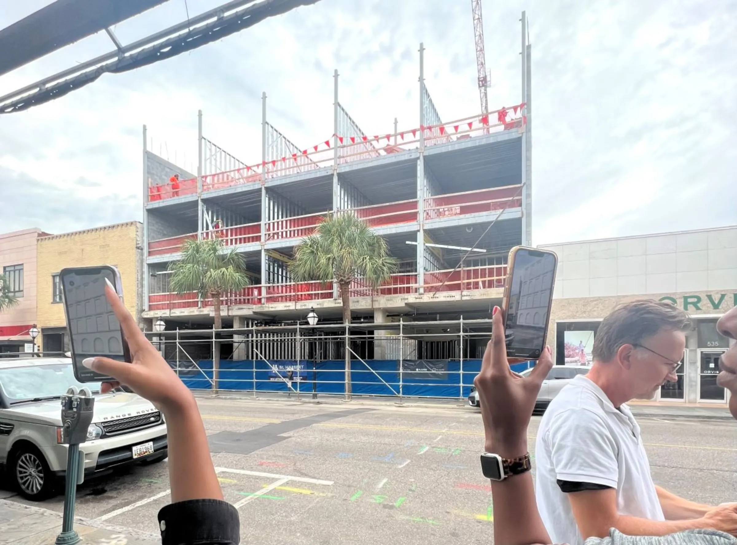 People use their phones to look at augmented-reality images of new construction in Charleston, South Carolina, in September 2023. inCitu/Handout via Thomson Reuters Foundation