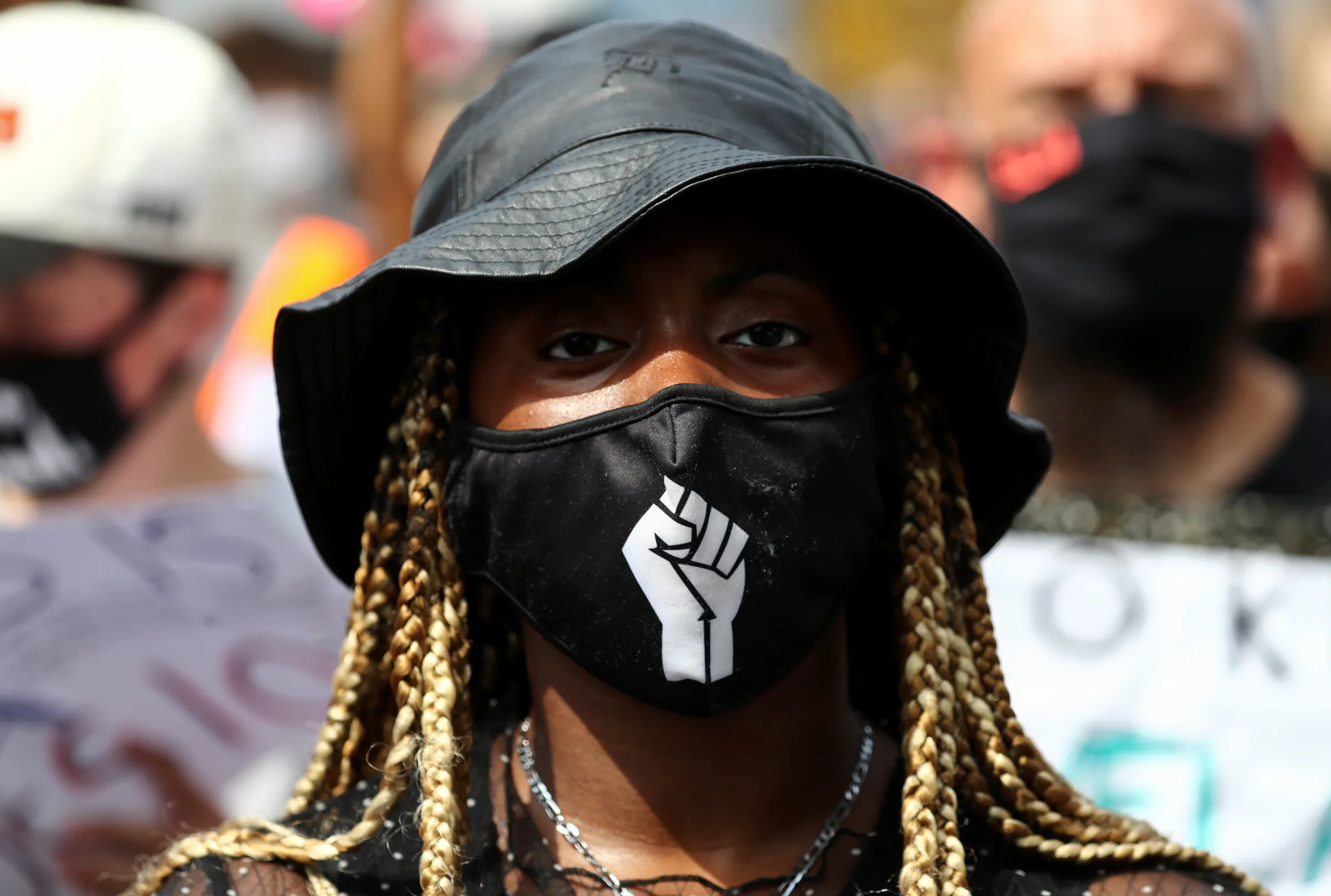 A demonstrator looks on during a Black Lives Matter protest outside Tottenham police station in London, Britain