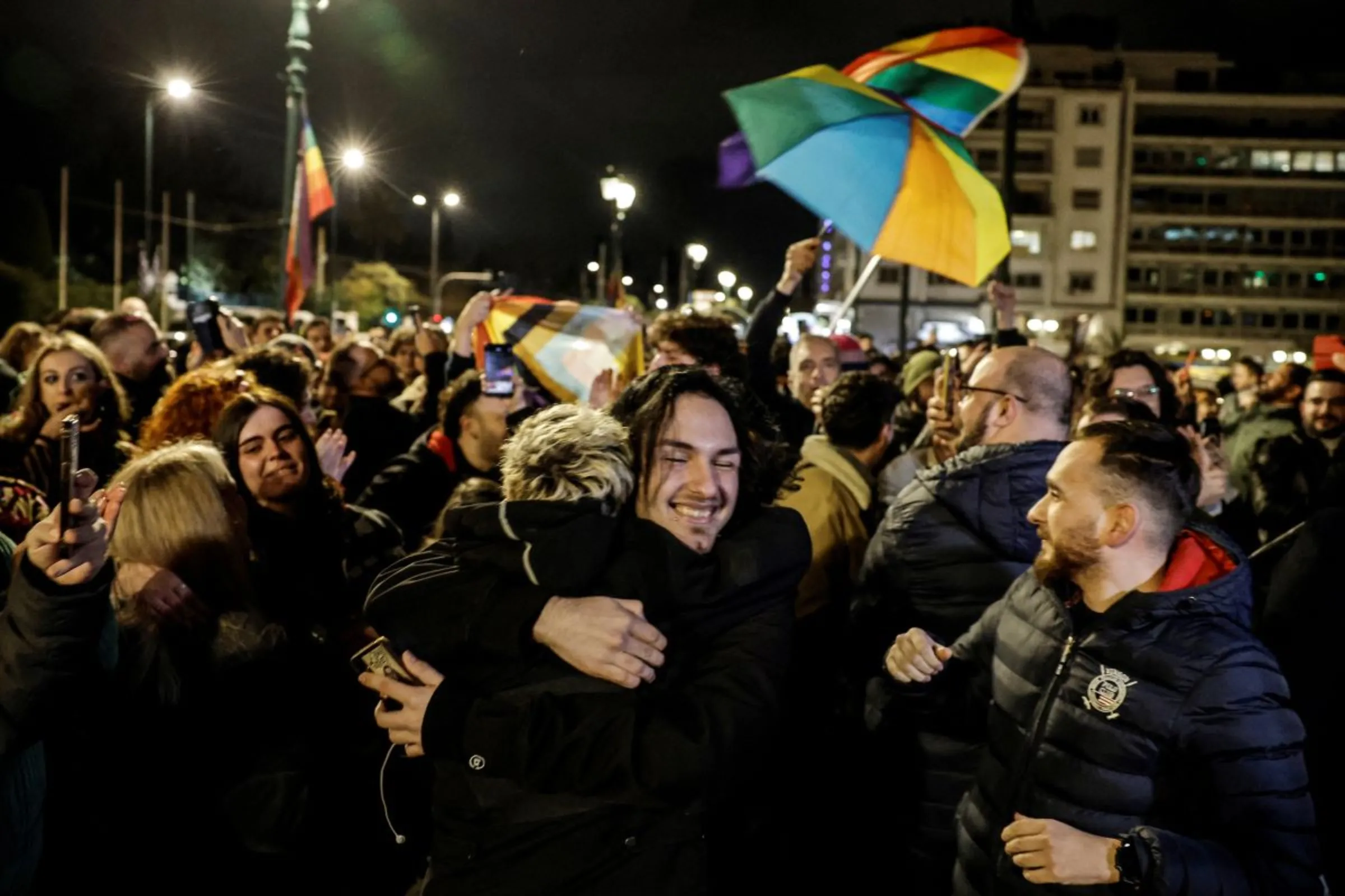 Members of the LGBTQ+ community and supporters celebrate in front of the Greek parliament, after the vote in favour of a bill which approved allowing same-sex civil marriages, in Athens, Greece, February 15, 2024. REUTERS/Louisa Gouliamaki