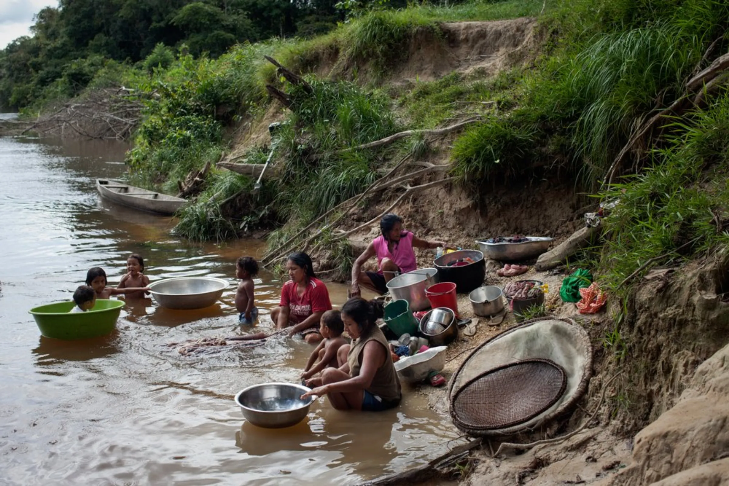 Women of the Puerto Libre community wash pots, pans and clothes in the Miriti-Parana River in Colombia’s southeast Amazonas province, December 16, 2021