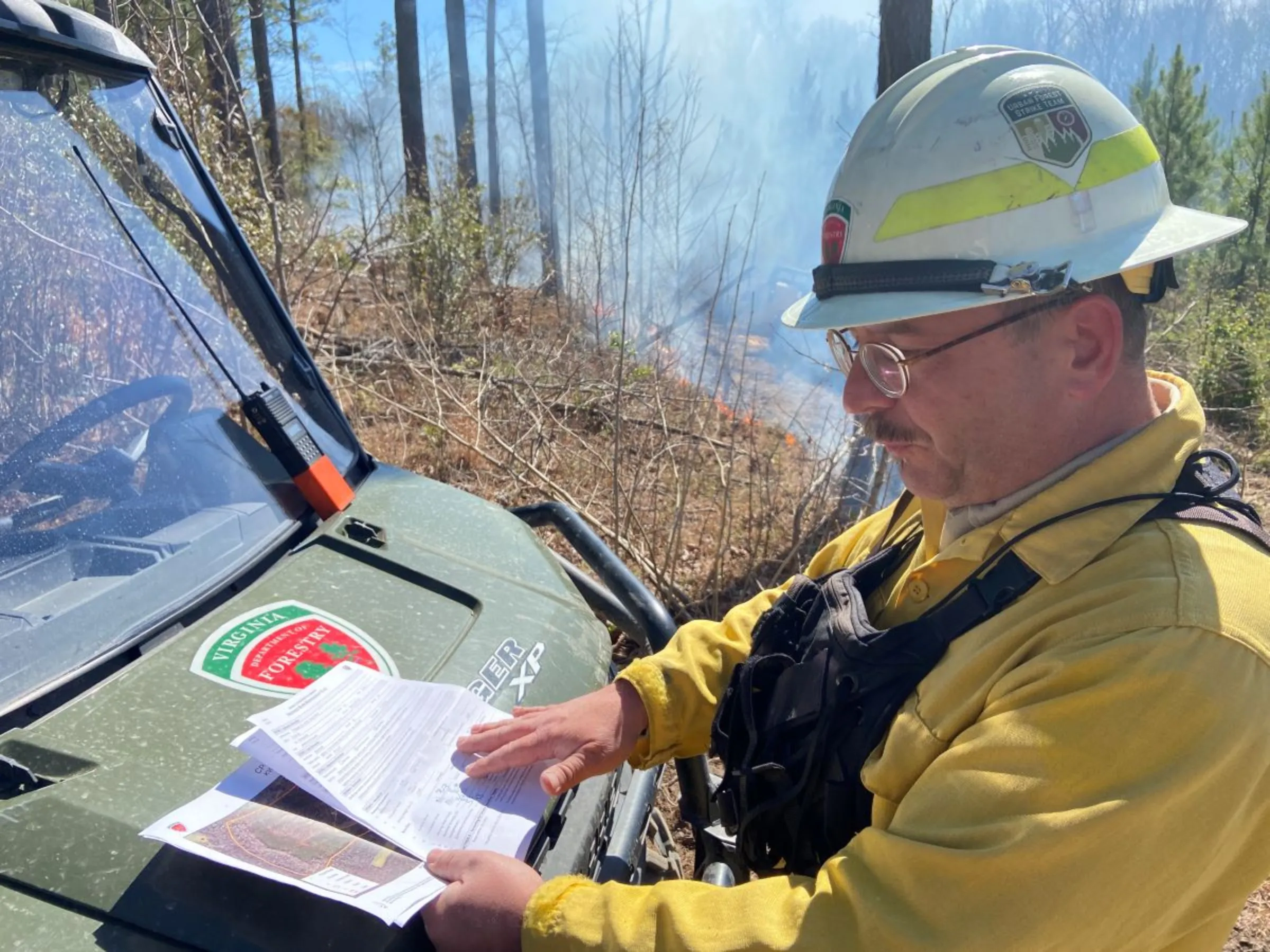 Forester Dave Slack with the Virginia Department of Forestry goes over the plan for a controlled burn in King William County, Virginia, USA, March 9, 2023. Thomson Reuters Foundation/David Sherfinski.