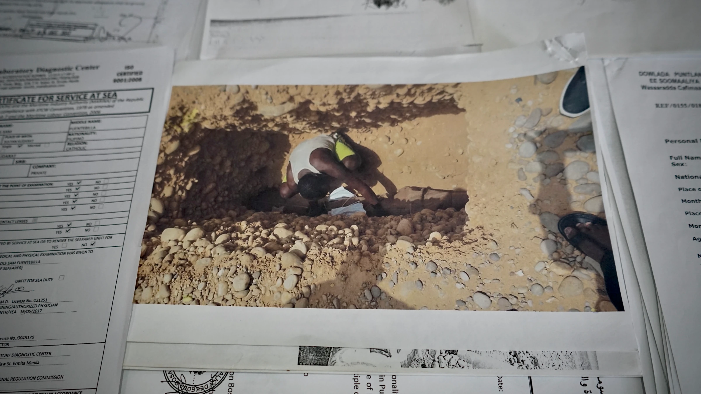A burial confirmation photo relayed by a former fishing colleague shows Sam Dela Cruz being buried at a public graveyard in Somalia on July 29, 2018, one day after his death. Sultan Kudarat, Philippines, June 4, 2025. Thomson Reuters Foundation/Raizza Bello