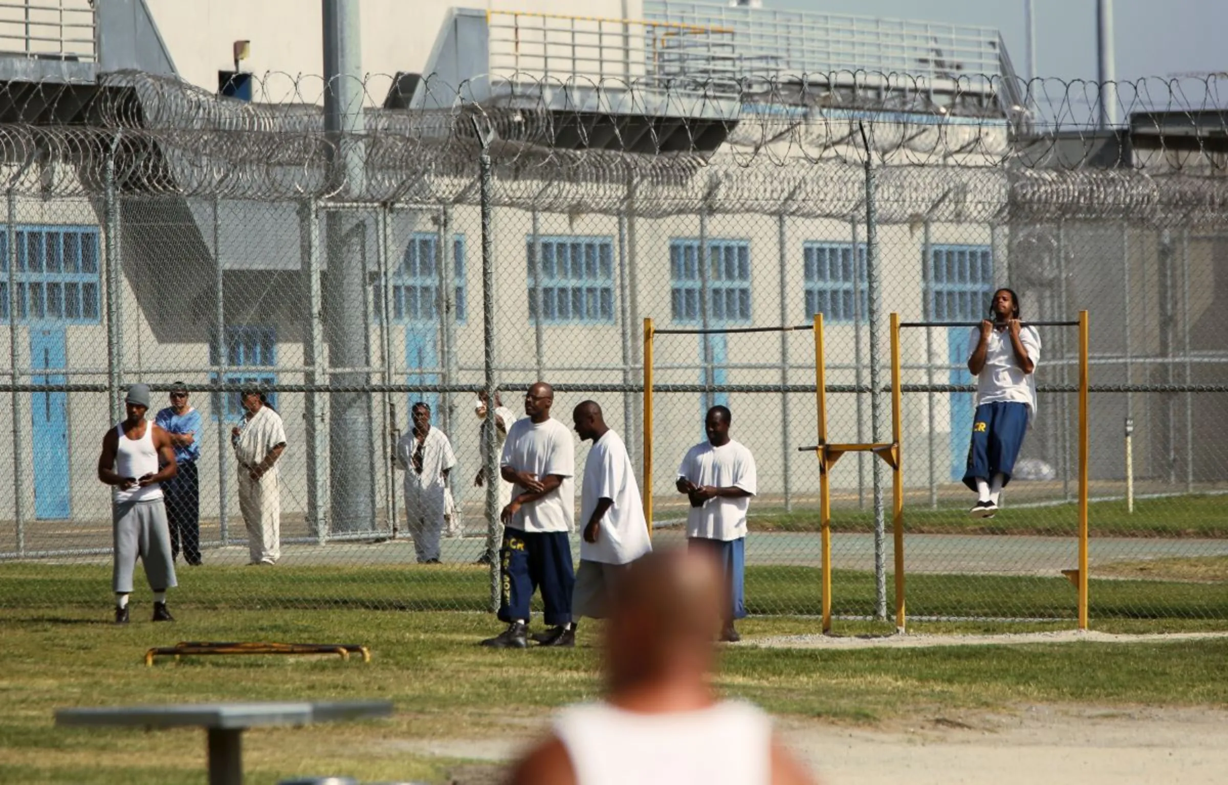 Inmates workout in the yard at Corcoran State Prison, 
California October 1, 2013. REUTERS/Robert Galbraith