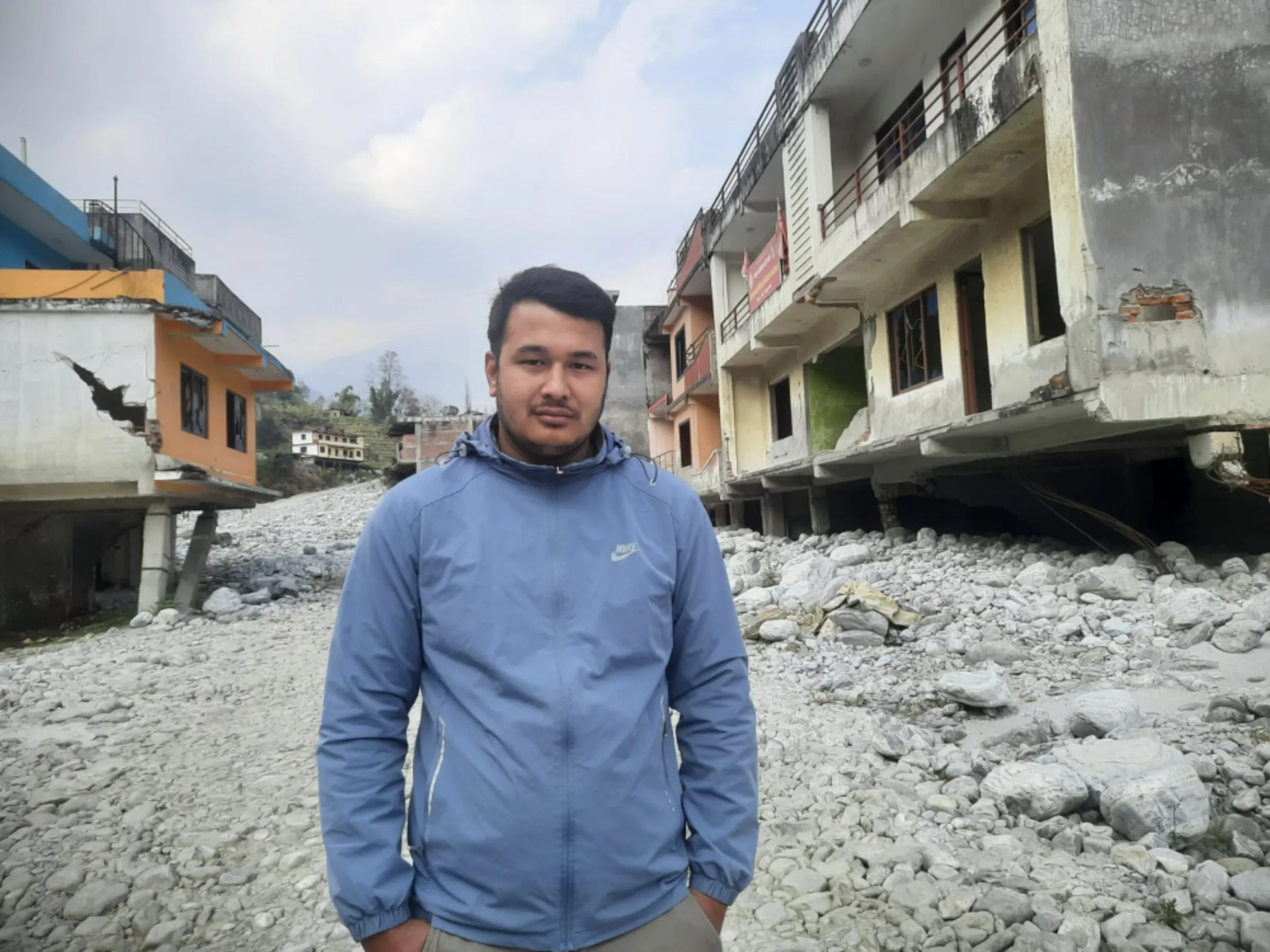 Upendra Kachhapati, the son of Gynendra Kachhapati, who lost his life in a glacial lake outburst flood on the Melamchi river, stands at the site of the flood, February 18, 2023