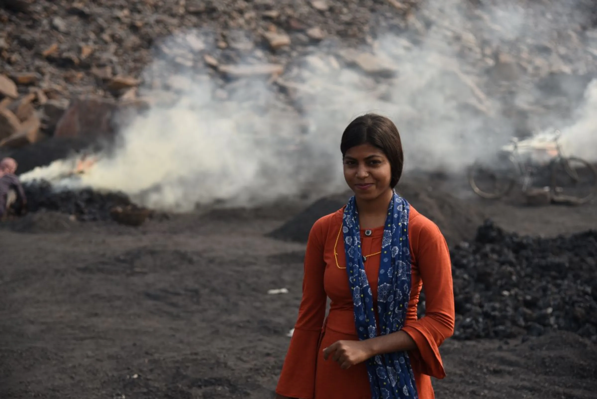 Suman Kumari poses for a picture at a burning coalfield in Jharia, India, November 11, 2022. Thomson Reuters Foundation/Tanmoy Bhaduri