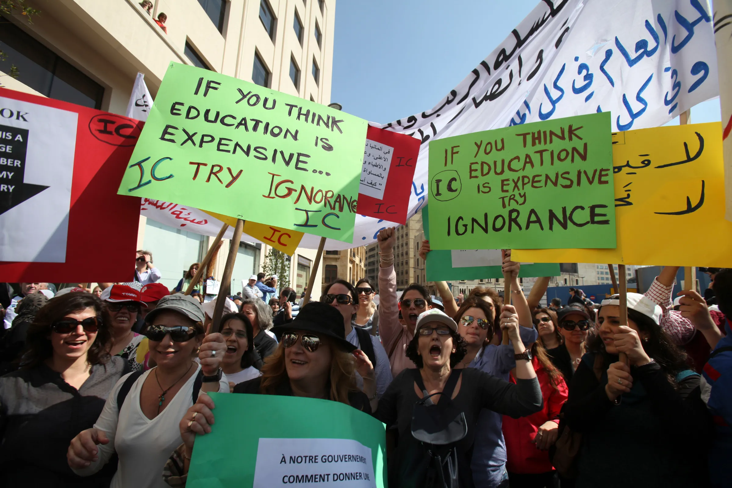 Teachers hold placards during a protest in front of the Grand Serail in Beirut