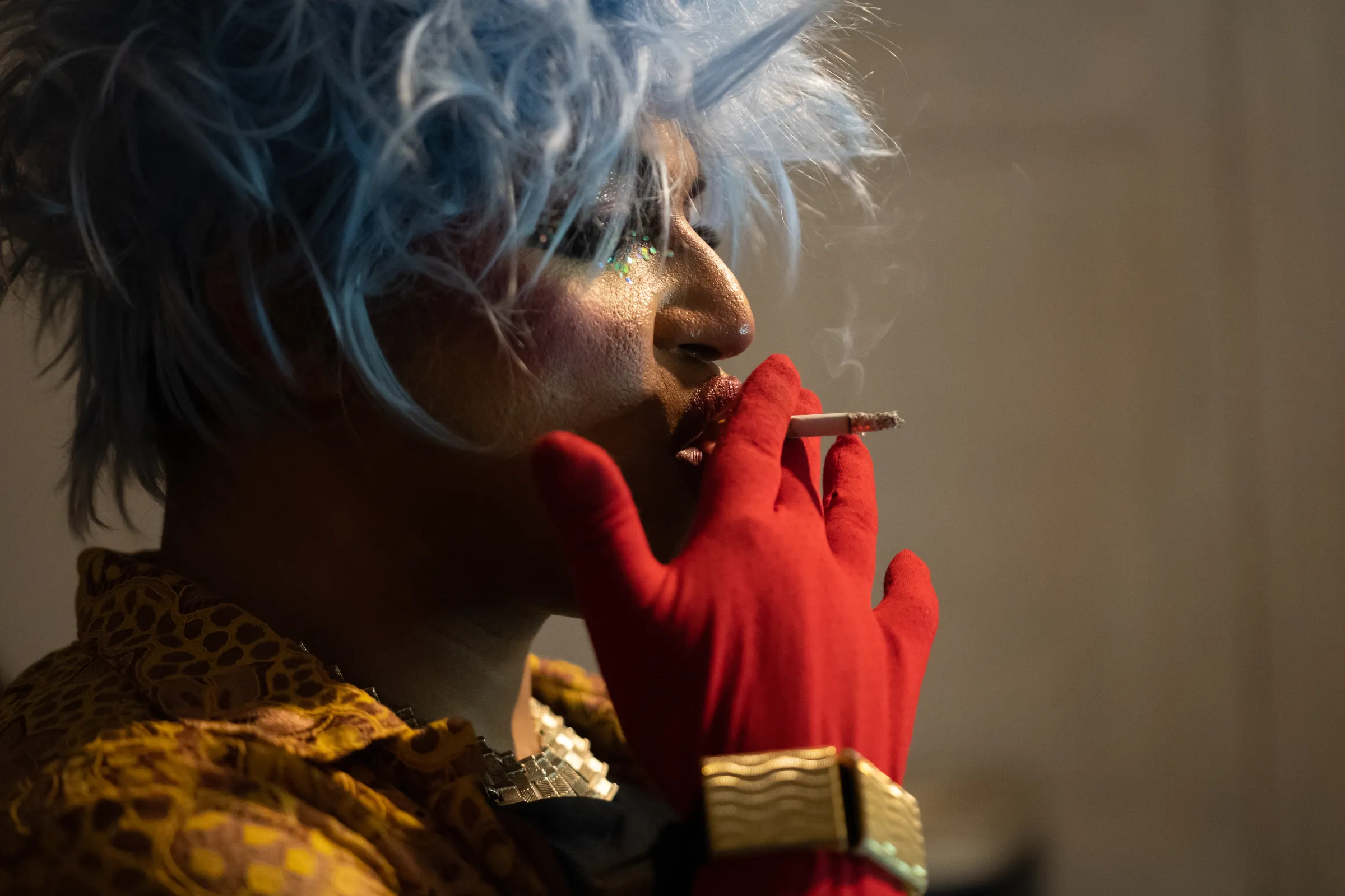 Manu Portillo as Maldad Drag takes a drag from her cigarette backstage before heading out to MC the runway in Asunción, Paraguay, February 22, 2023