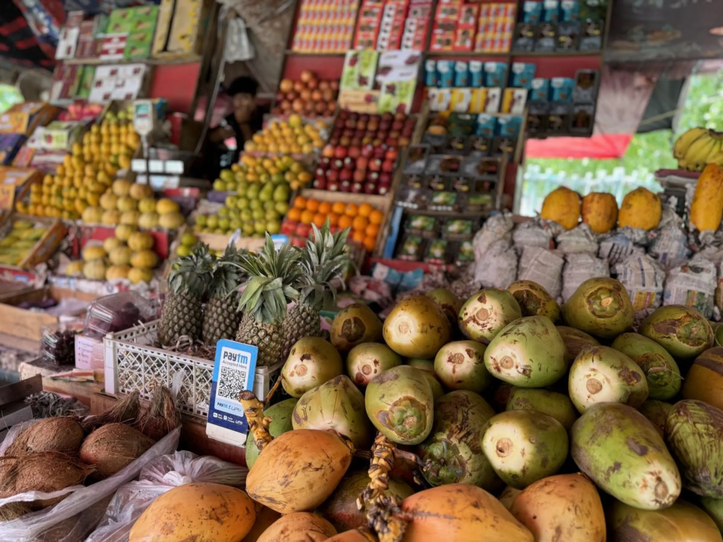 A street fruit vendors displays all the produce at his shop in Noida, India, on June 20, 2024. Thomson Reuters Foundation/Bhasker Tripathi
