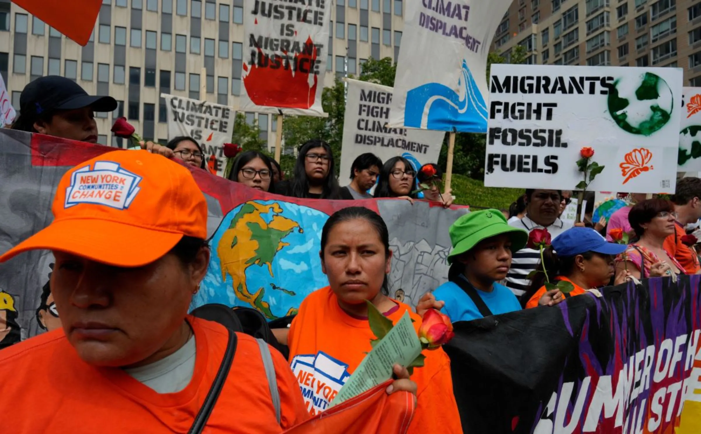 Climate activists, including migrants and displaced people, march to the global headquarters of Citigroup in New York City, U.S., August 16, 2024. REUTERS/Adam Gray