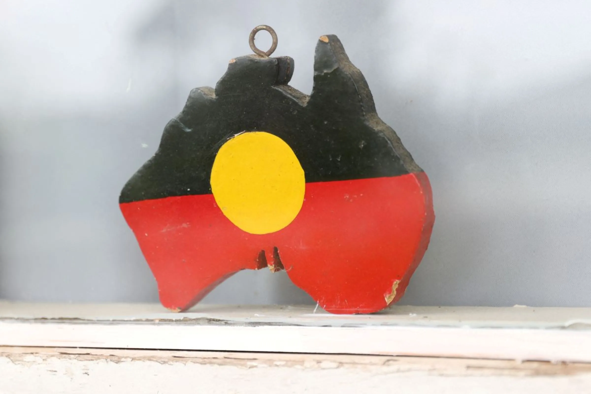 A depiction of the Australian Aboriginal Flag is seen on a window sill at the home of indigenous Muruwari elder Rita Wright, a member of the 'Stolen Generations', in Sydney, Australia, January 19, 2021