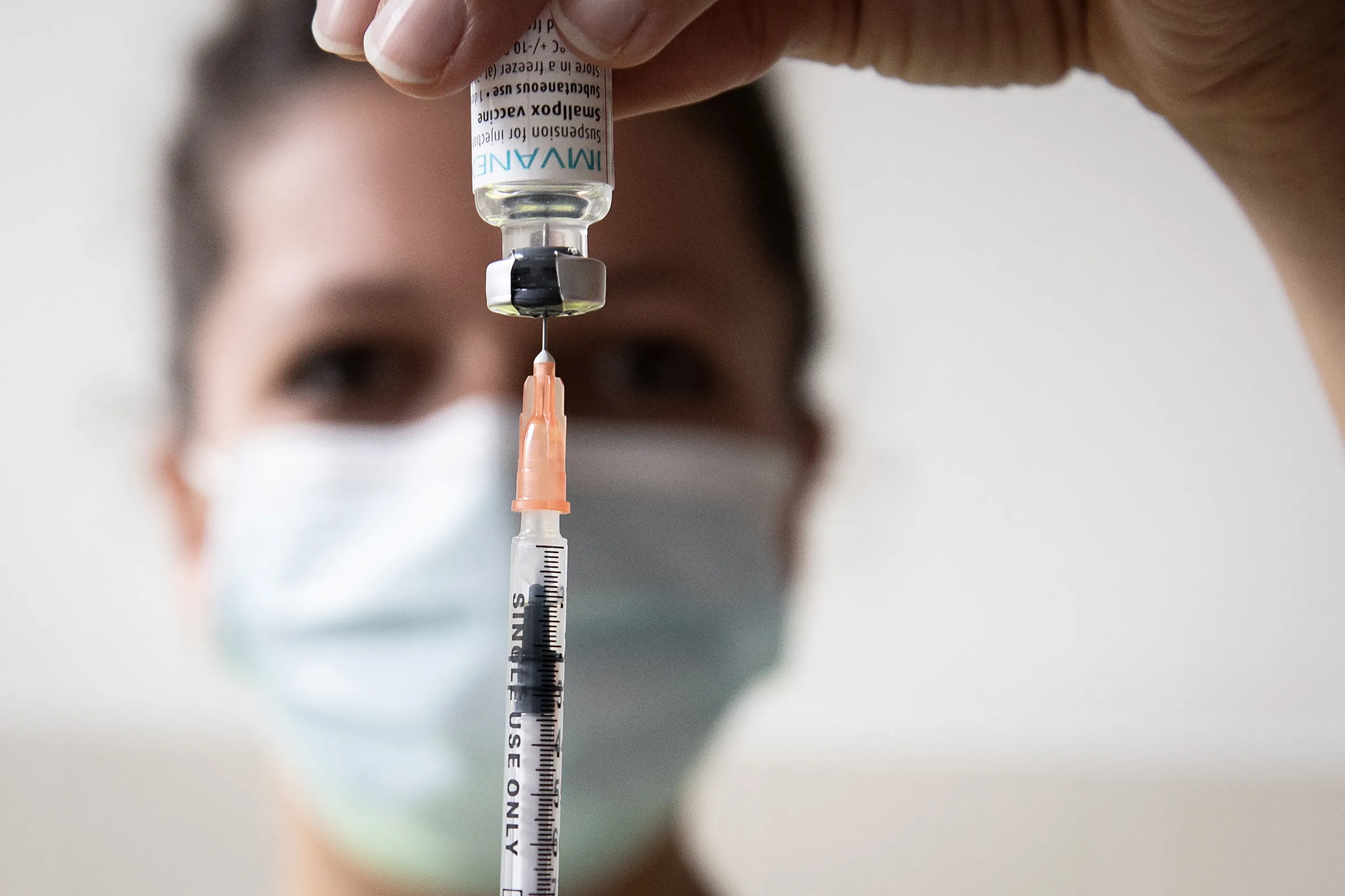 A medical health worker prepares a dose of the Monkeypox vaccine at the Edison municipal vaccination centre