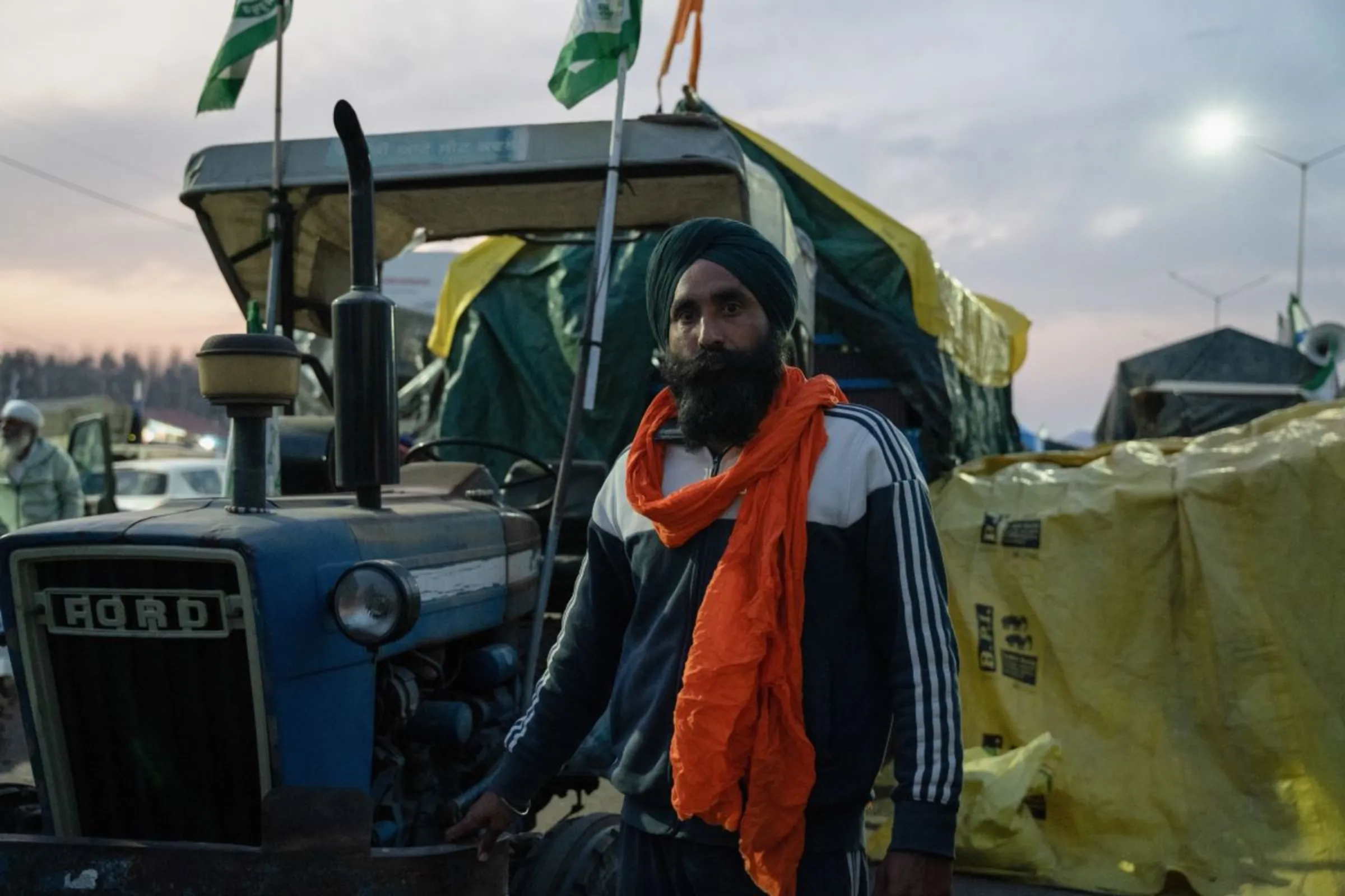 Taranjeet Singh, a protesting farmer, poses for a photo in front of his tractor at Shambhu Barrier, India, February 21, 2024. Thomson Reuters Foundation/Mehran Firdous