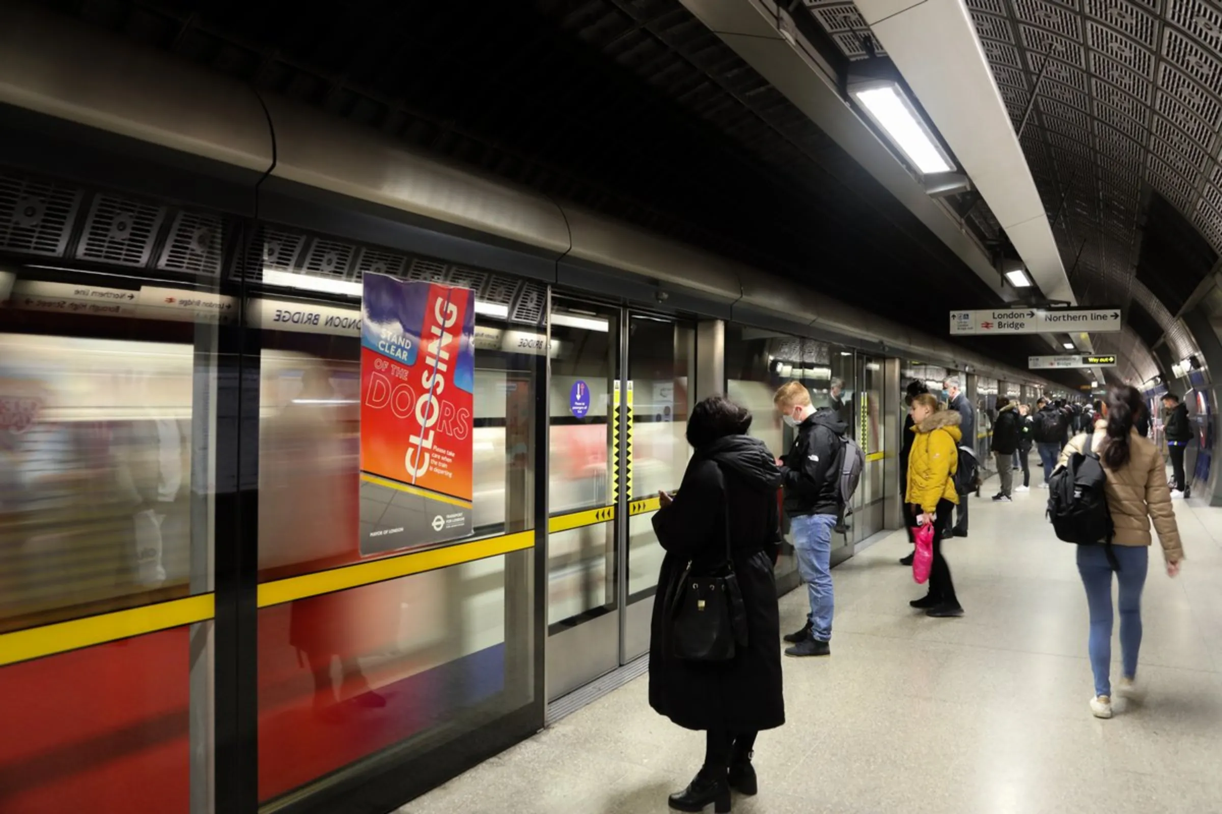 Commuters await the arrival of a Jubilee Line subway train at London Bridge Underground Station in London, England, on October 21, 2021