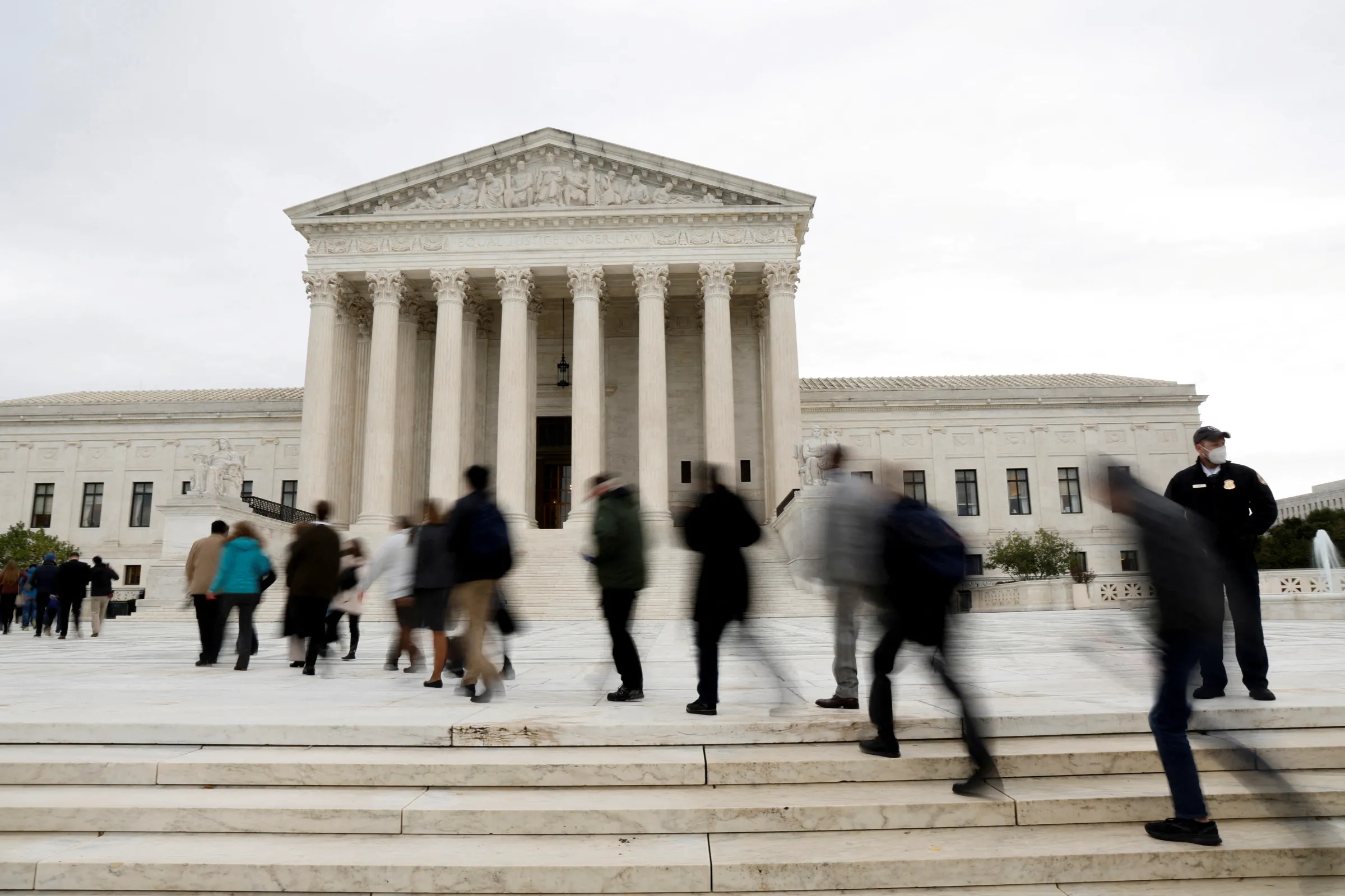 People walk across the plaza to enter the U.S. Supreme Court building on the first day of the court's new term in Washington, U.S. October 3, 2022