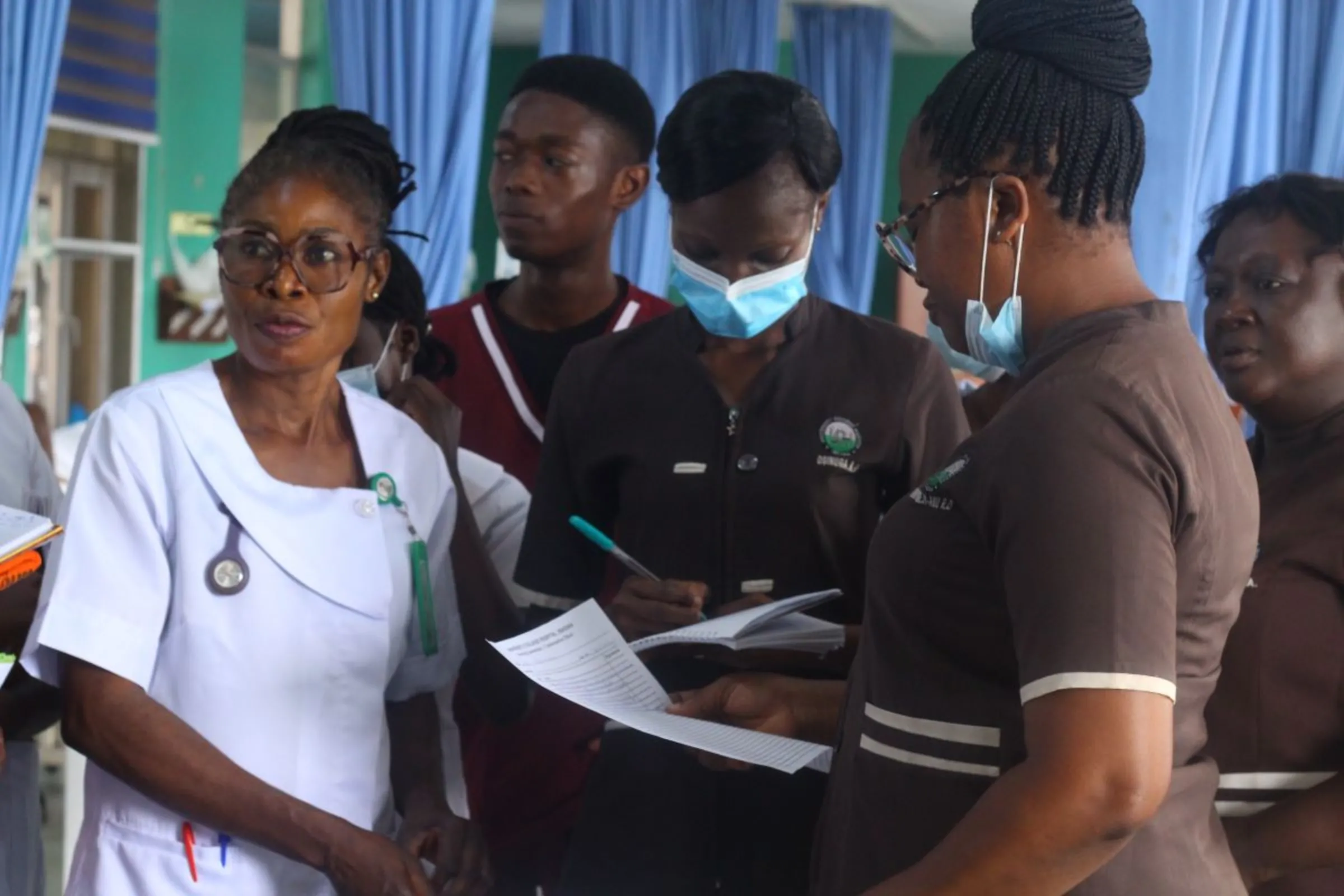 Nurses during a ward round at the University Teaching College Hospital, Ibadan in Nigeria on May 8, 2023. Bukola Adebayo/Thomson Reuters Foundation.