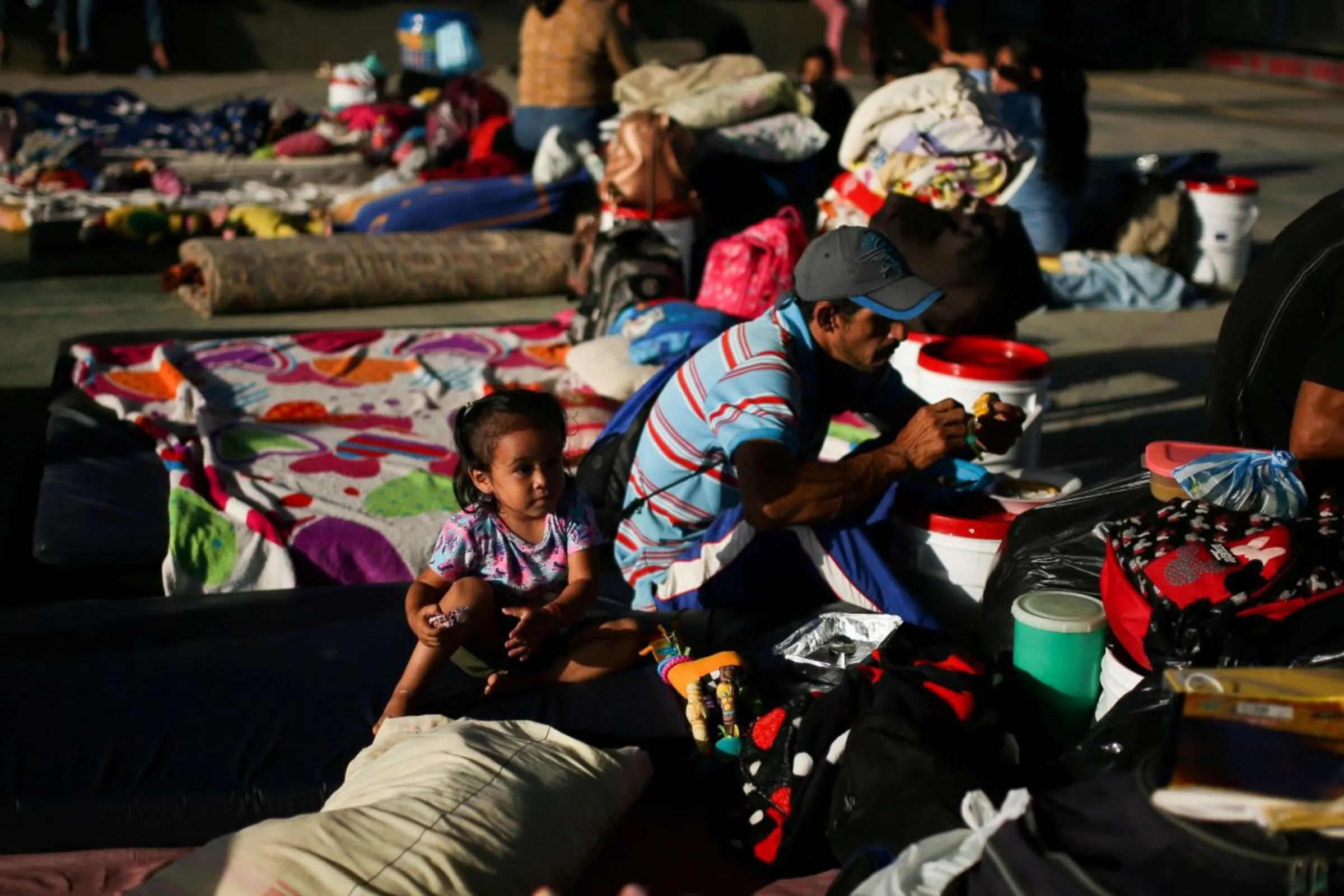 Venezuelan migrants are seen inside a coliseum where a temporary camp has been set up, after fleeing their country due to military operations, according to the Colombian migration agency, in Arauquita, Colombia March 27, 2021. REUTERS/Luisa Gonzalez