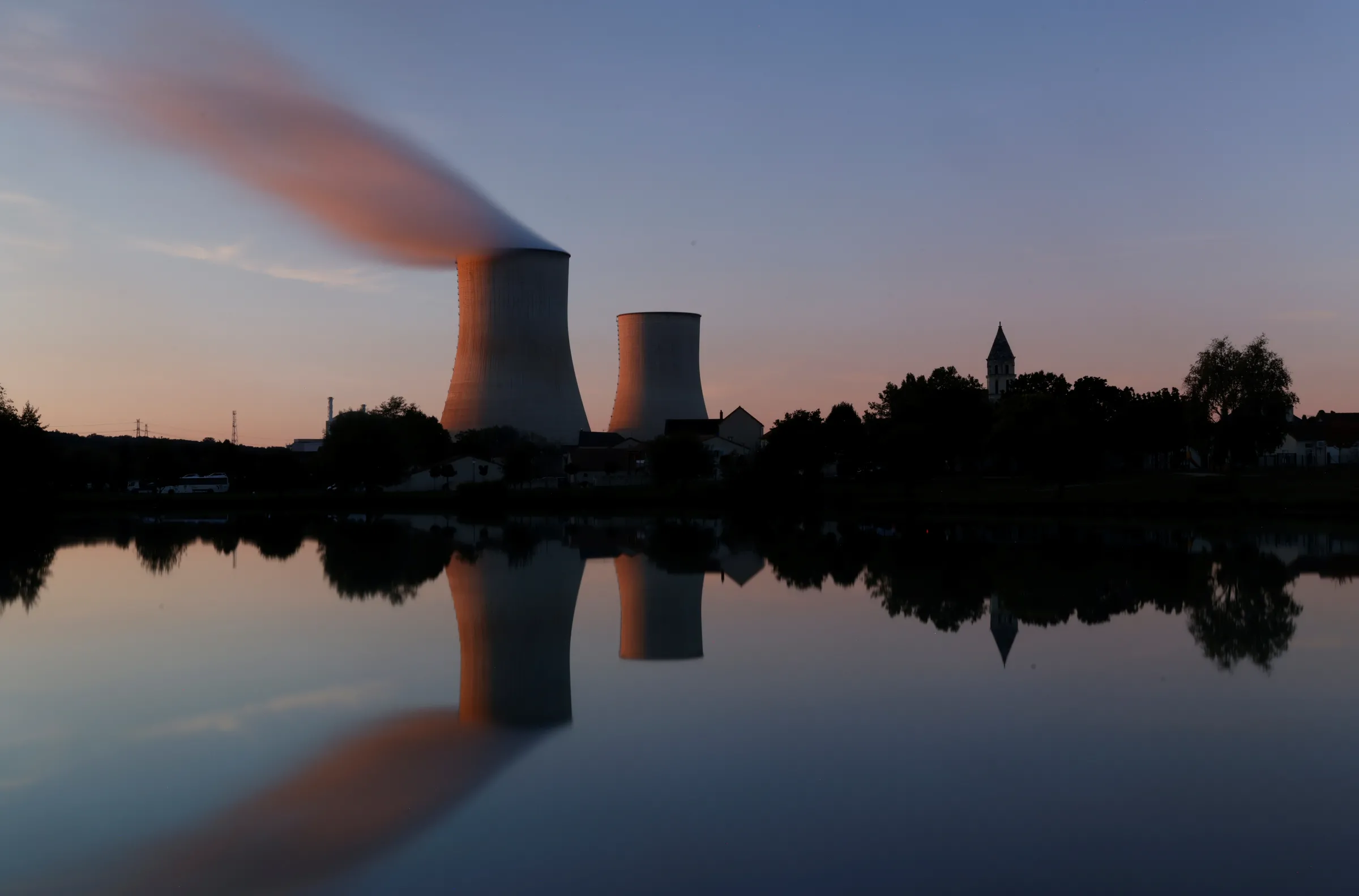 Steam rises from a cooling tower at a nuclear power station in Civaux, France