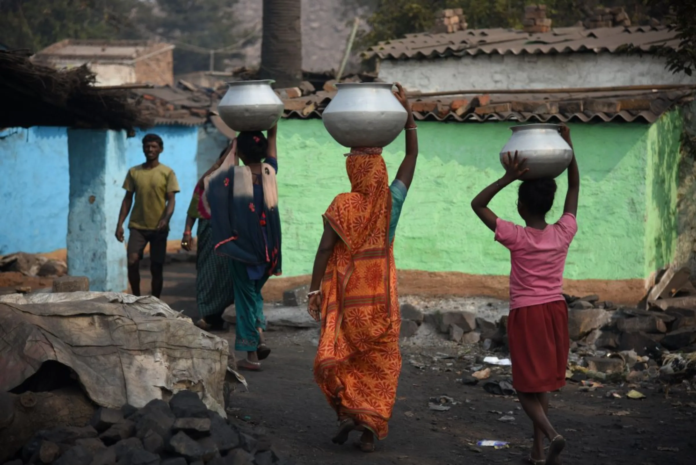 Women prepare for their weekly bath at Golakdhi settlement in Jharia coalfield, India, on November 10, 2022. Thomson Reuters Foundation/Tanmoy Bhaduri