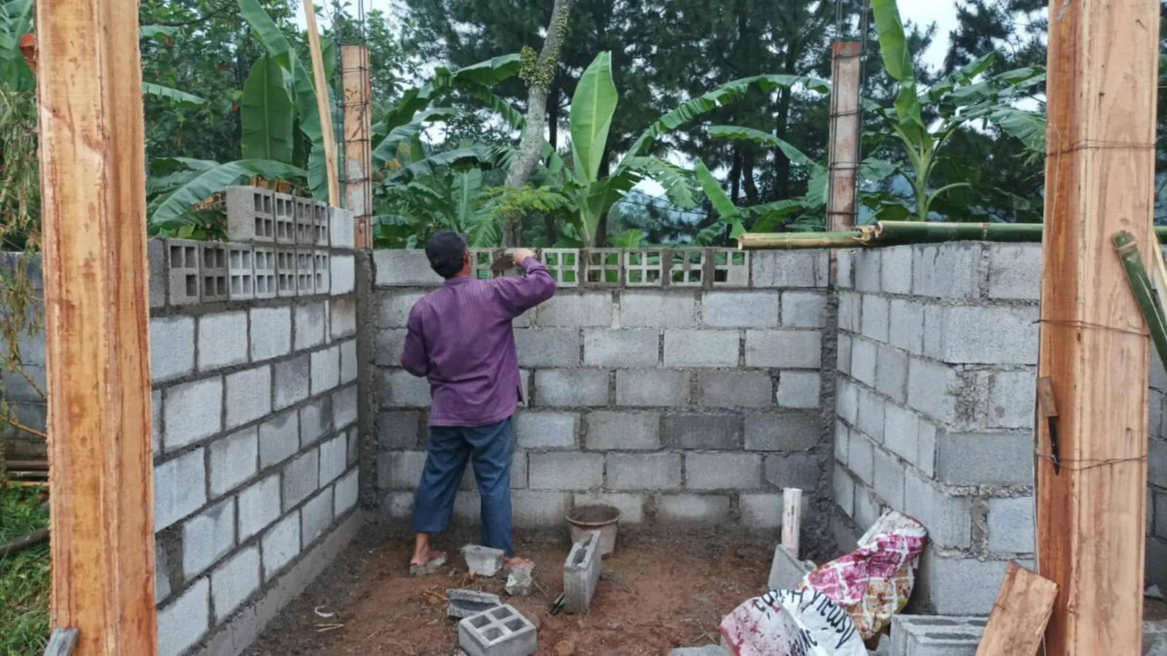 A builder uses eco-bricks by Rebricks to constructs toilet facilities for community trash collectors in south Jakarta, Indonesia on December 9, 2021. Ovy Sabrina/Handout via Thomson Reuters Foundation