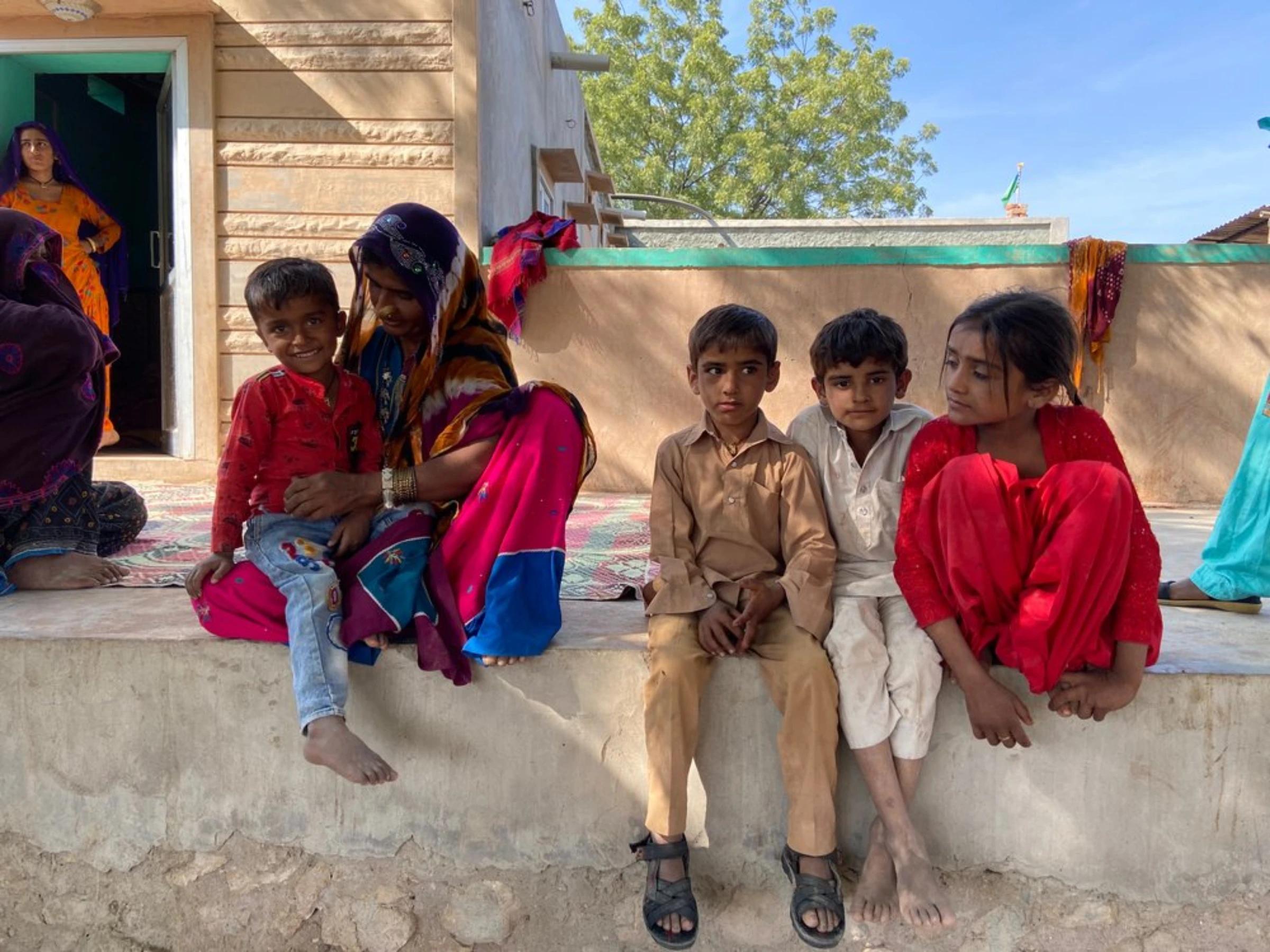 Dadda Khatoon (left) plays with children of her village near Bhadla Solar Park, Rajasthan, India, December 11, 2021