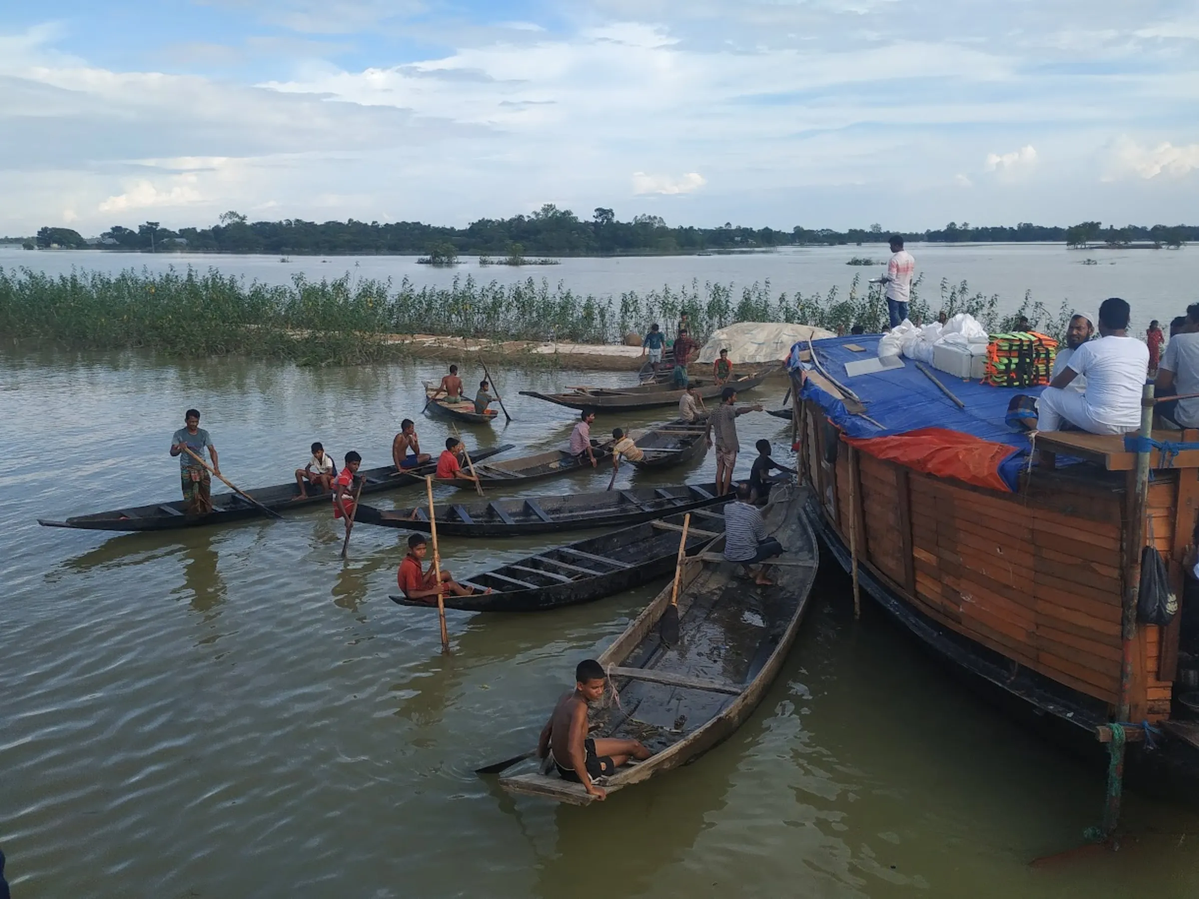 Volunteers distribute relief in the flood-affected Sunamganj region