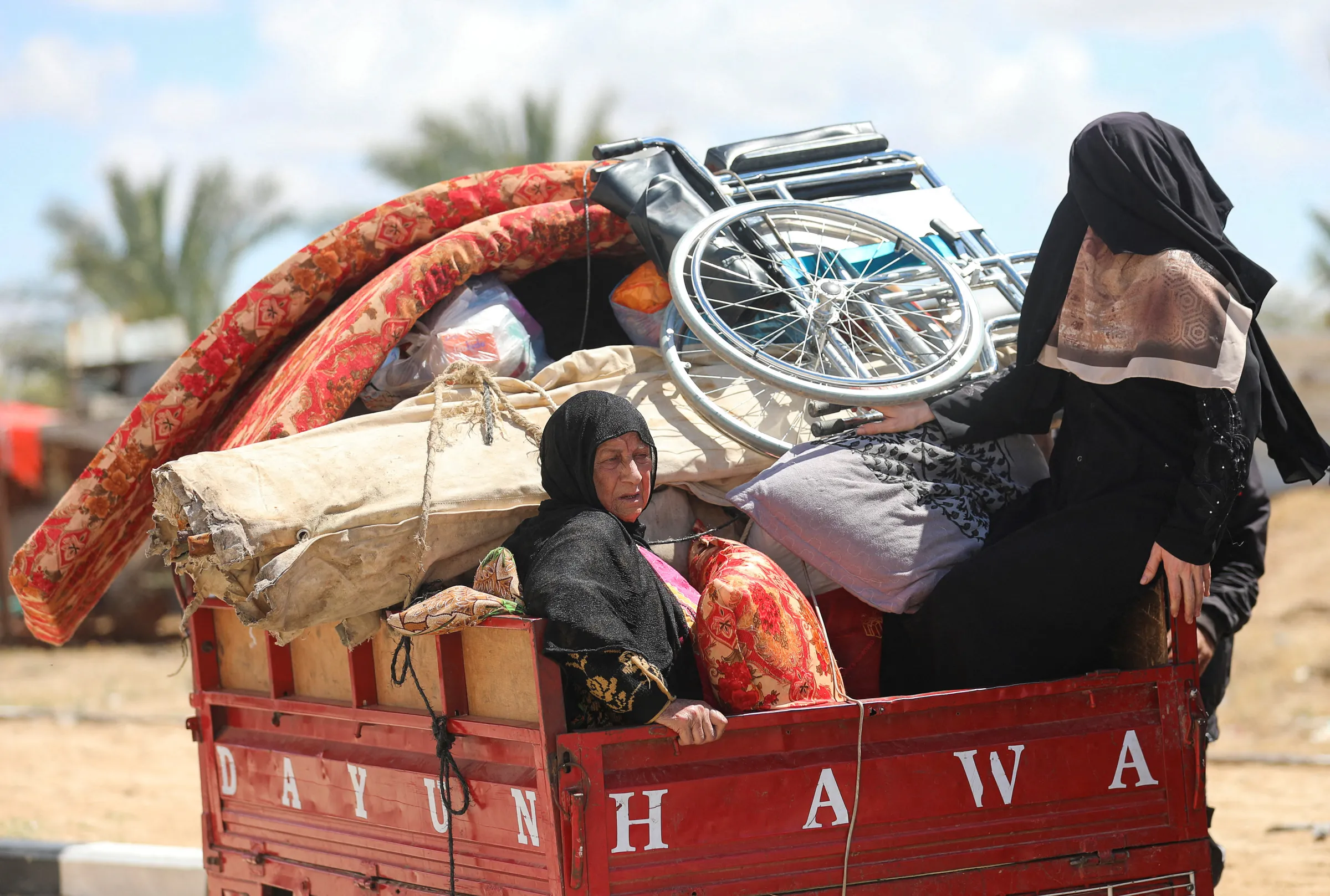 Displaced Palestinians, who fled Rafah after the Israeli military began evacuating civilians from the eastern parts of the southern Gaza city ahead of a threatened assault, travel in Al-Mawasi area, Gaza Strip, May 6, 2024. REUTERS/Ramadan Abed