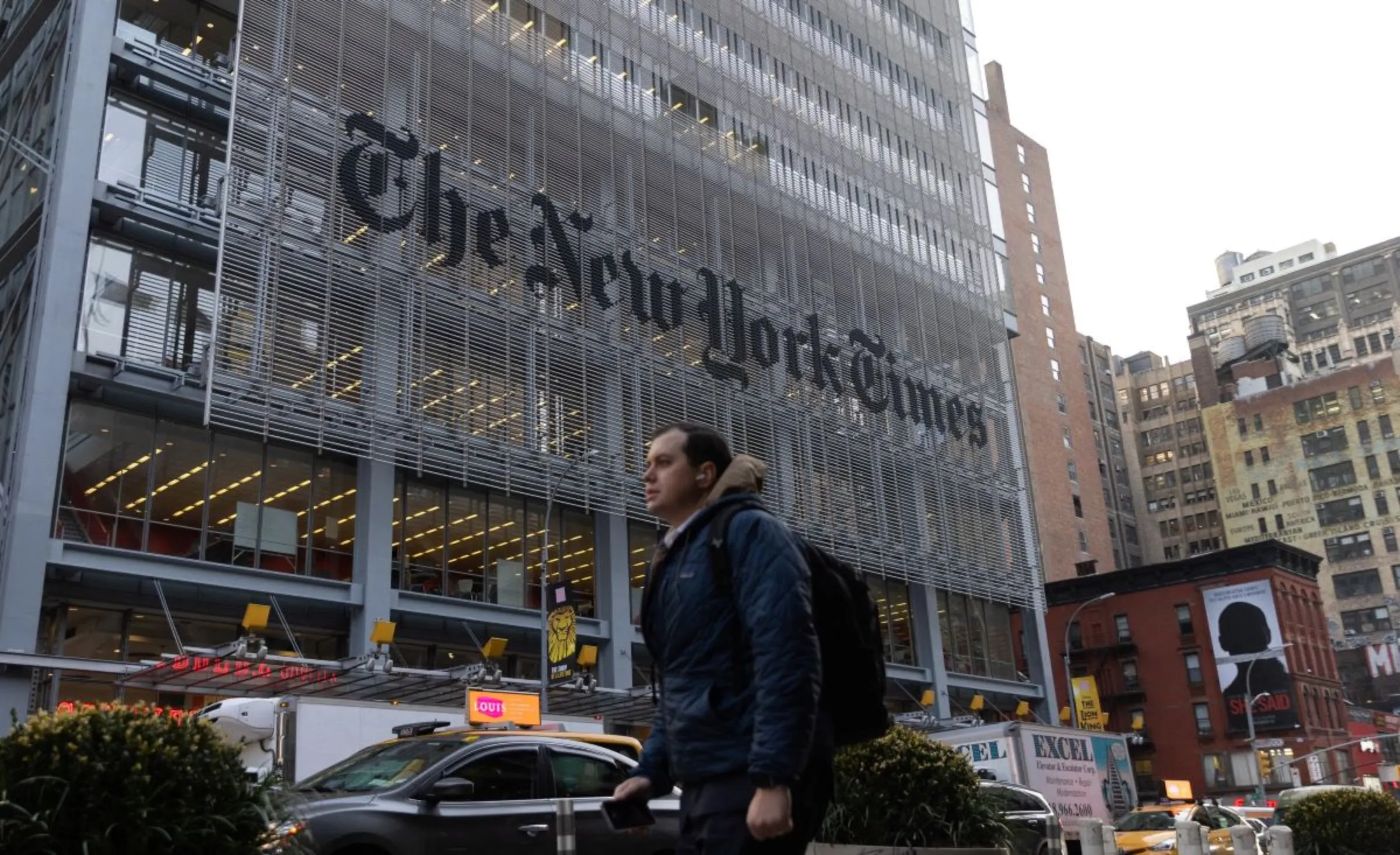 A pedestrian walks by the New York Times building in Manhattan, New York, U.S., December 8, 2022. REUTERS/Jeenah Moon