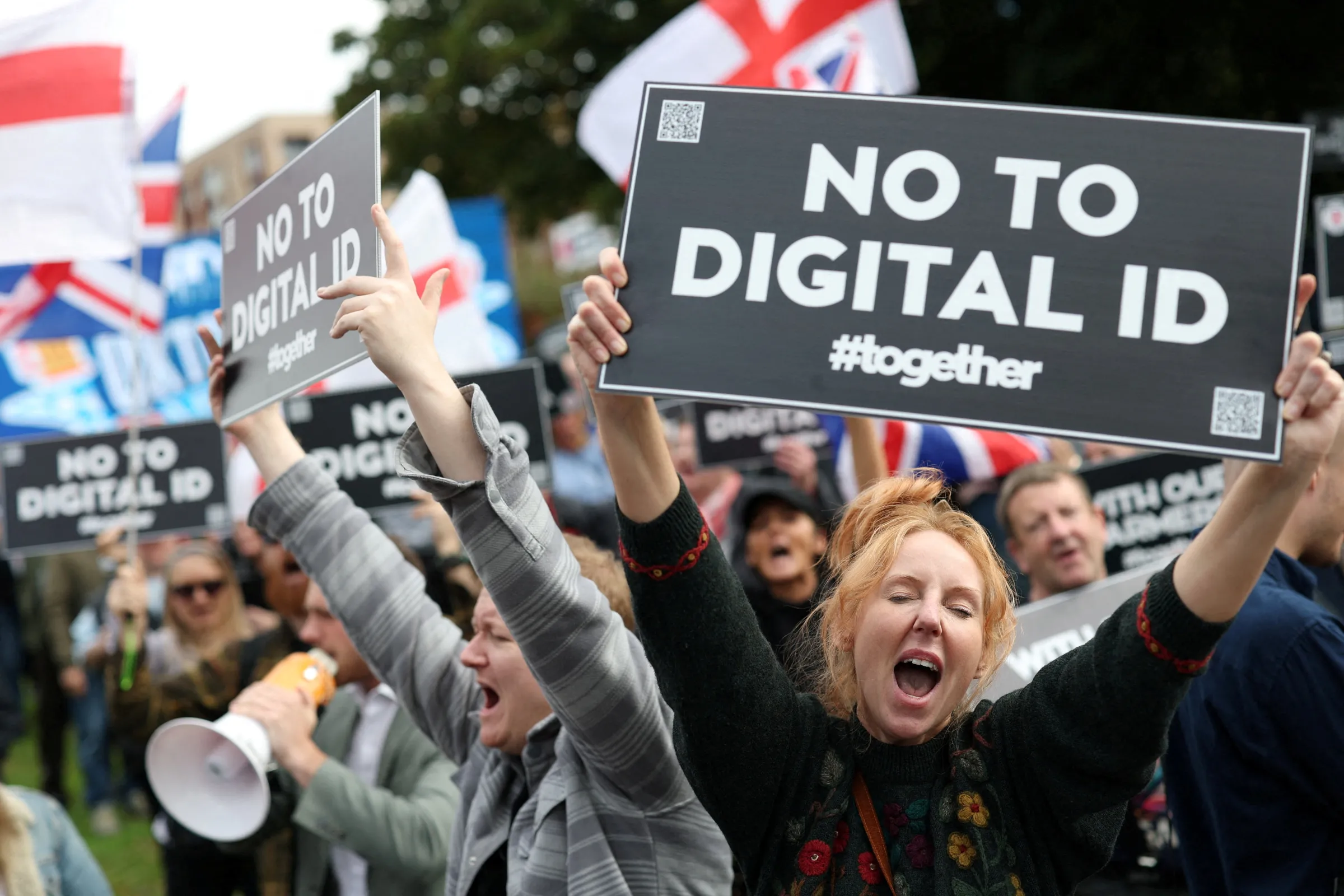 Protesters hold signs during a 'No to Digital ID' demonstration near to the Labour Party Conference in Liverpool, Britain, September 28, 2025. REUTERS/Hannah McKay