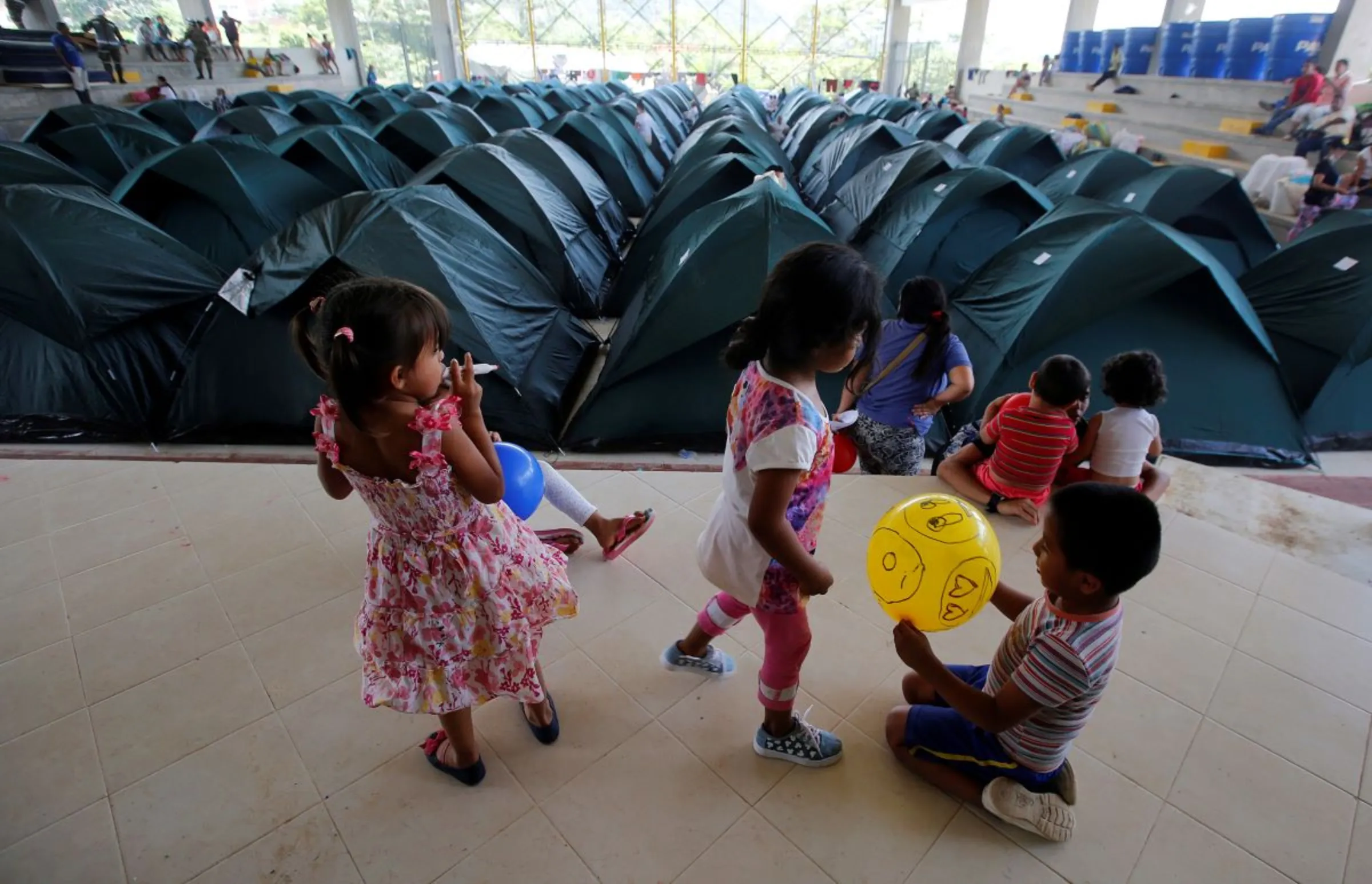 Children play in a shelter for people who became homeless after flooding and mudslides caused by heavy rains led several rivers to overflow, pushing sediment and rocks into buildings and roads in Mocoa, Colombia, April 4, 2017. REUTERS/Jaime Saldarriaga