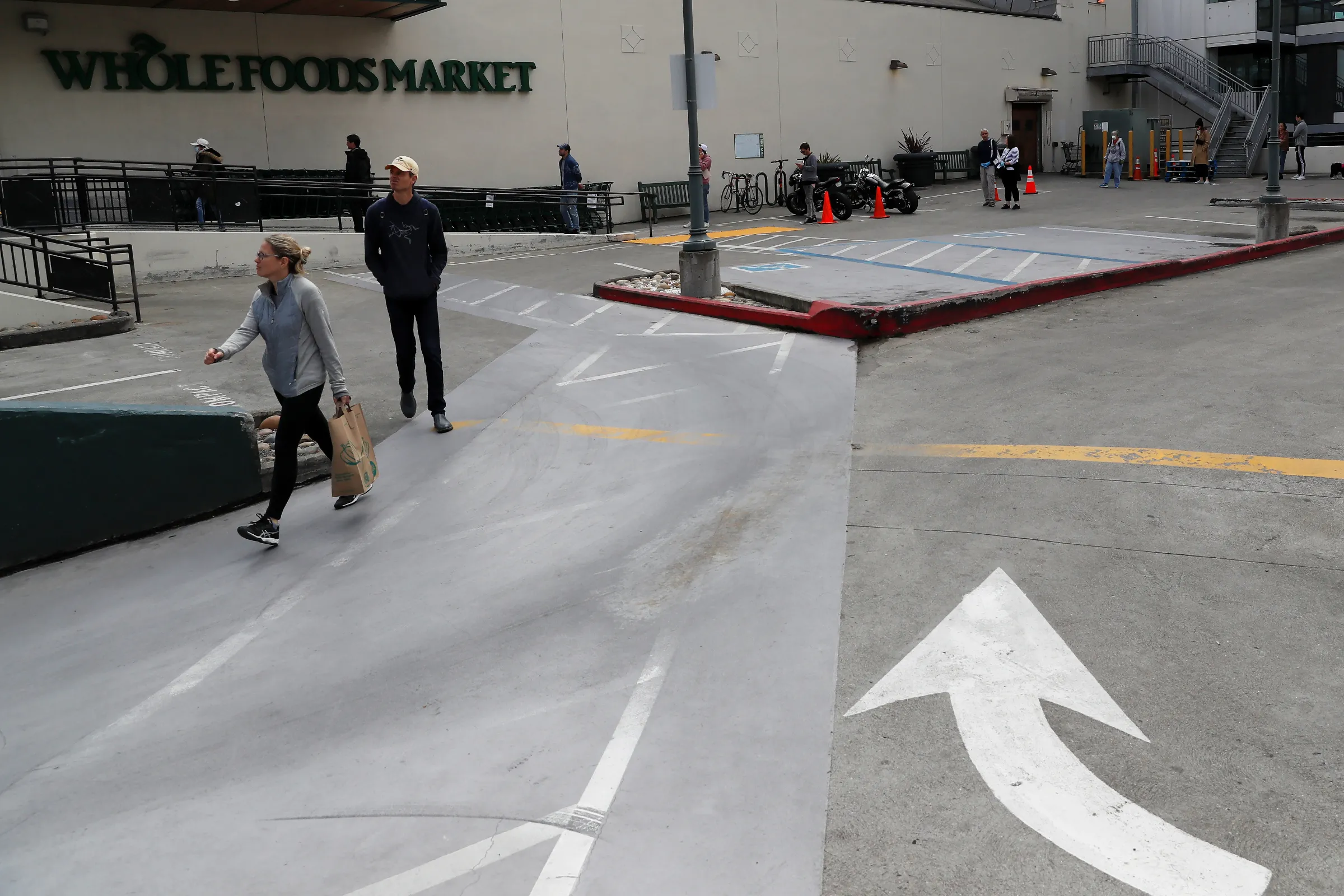 People wait in line practicing social distance at a Whole Foods Market amid an outbreak of the coronavirus disease (COVID-19), in San Francisco, California, U.S., March 31, 2020