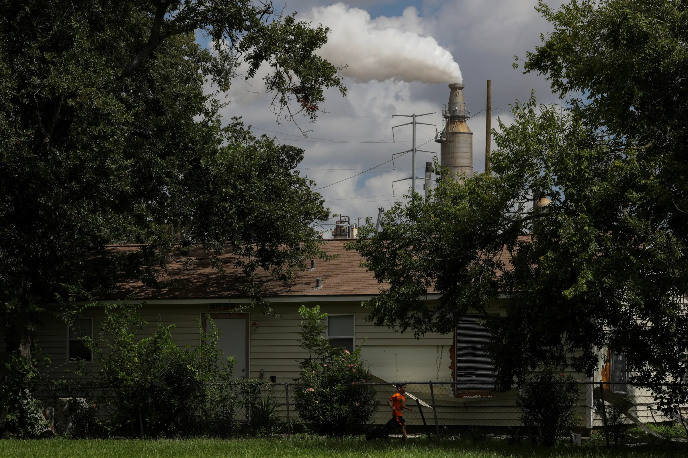A child runs through the backyard of a home in the Manchester neighbourhood of Houston, Texas, U.S., October 3, 2018. REUTERS/Loren Elliott