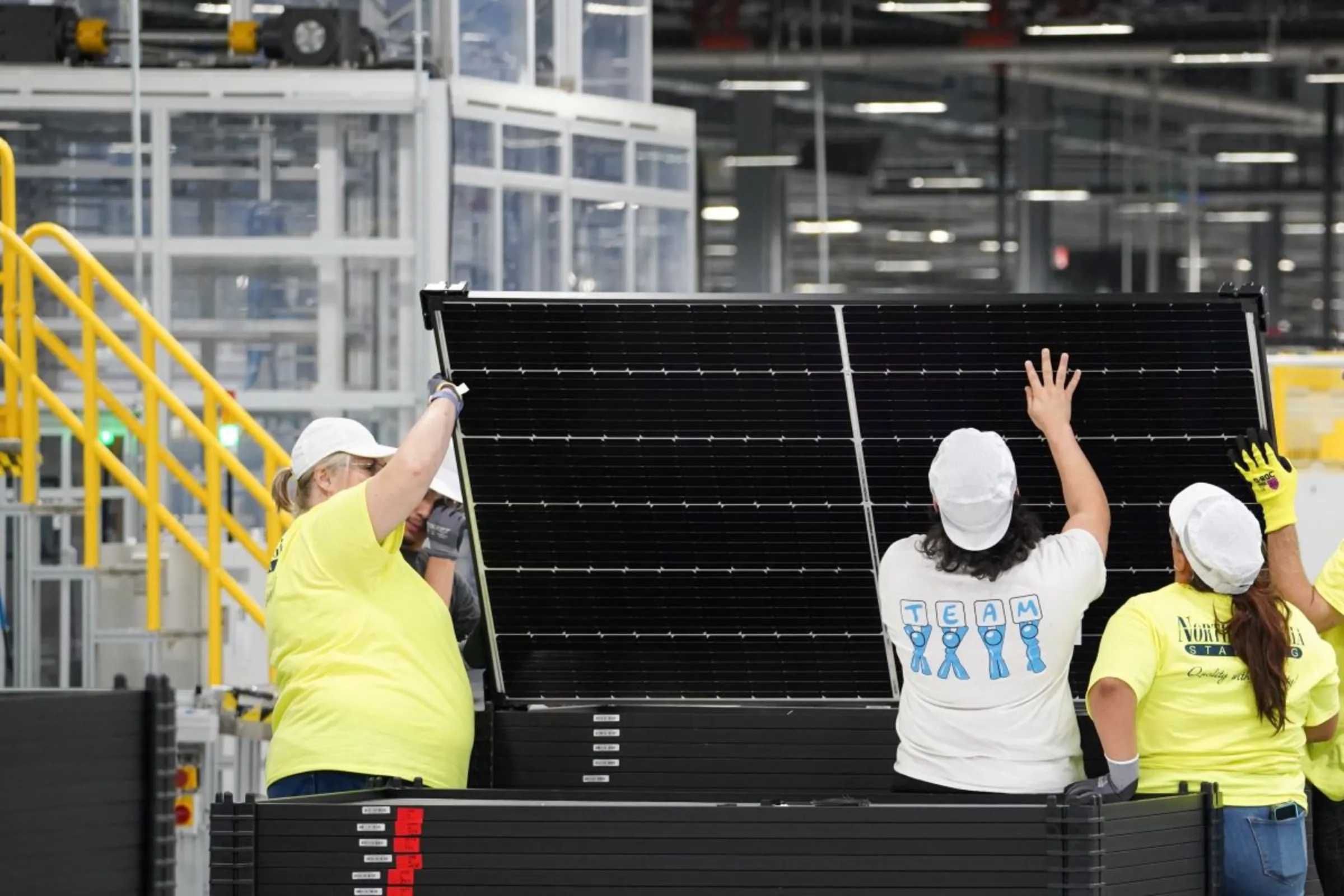 Employees work on solar panels at the QCells solar energy manufacturing factory in Dalton, Georgia, U.S., March 2, 2023