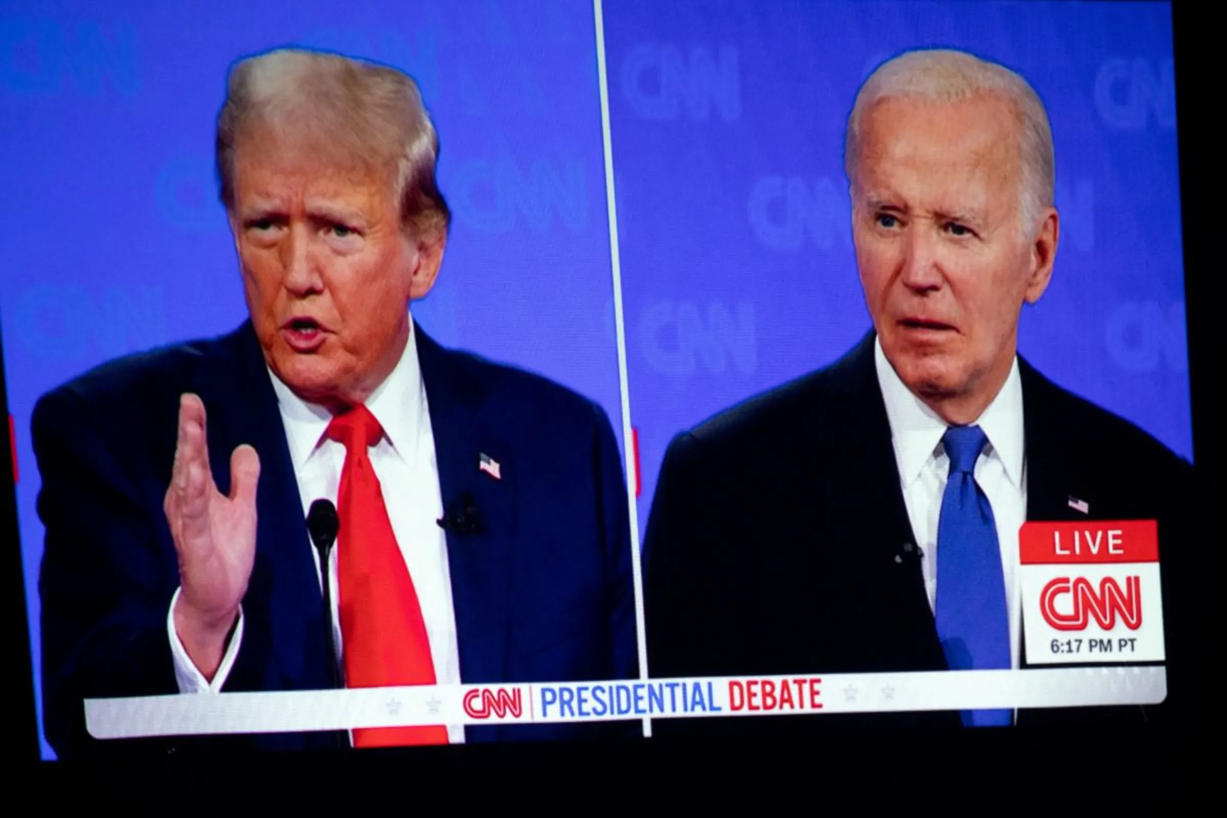 A debate between U.S. President Joe Biden and Republican presidential candidate Donald Trump is projected on a screen projector in Novi, Michigan, U.S., June 27, 2024. REUTERS/Emily Elconin