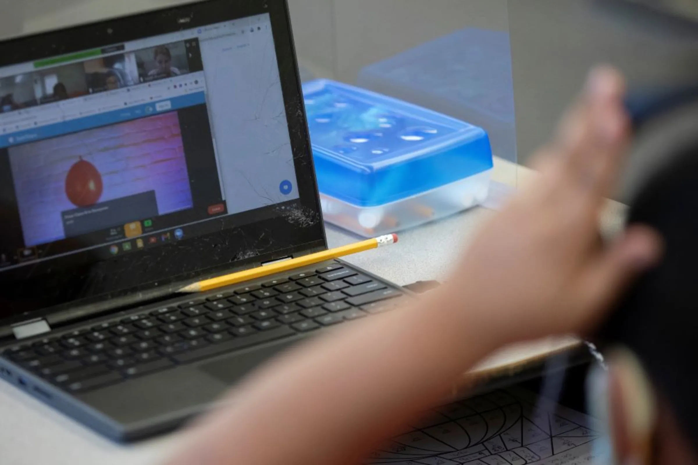 A student's pencil rests on a laptop during an in-person hybrid learning day at the Mount Vernon Community School in Alexandria, Virginia, U.S., March 2, 2021.REUTERS/Tom Brenner