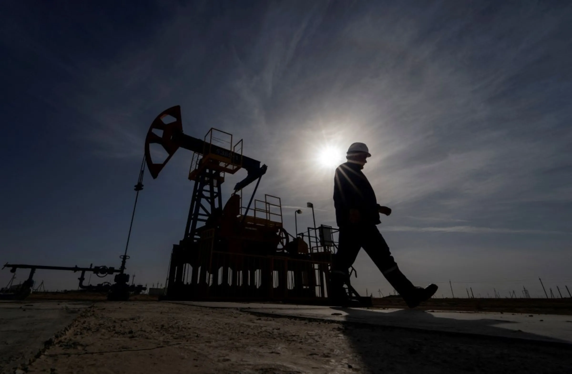 An oil and gas industry worker walks during operations of a drilling rig at Zhetybay field in the Mangystau region, Kazakhstan, November 13, 2023